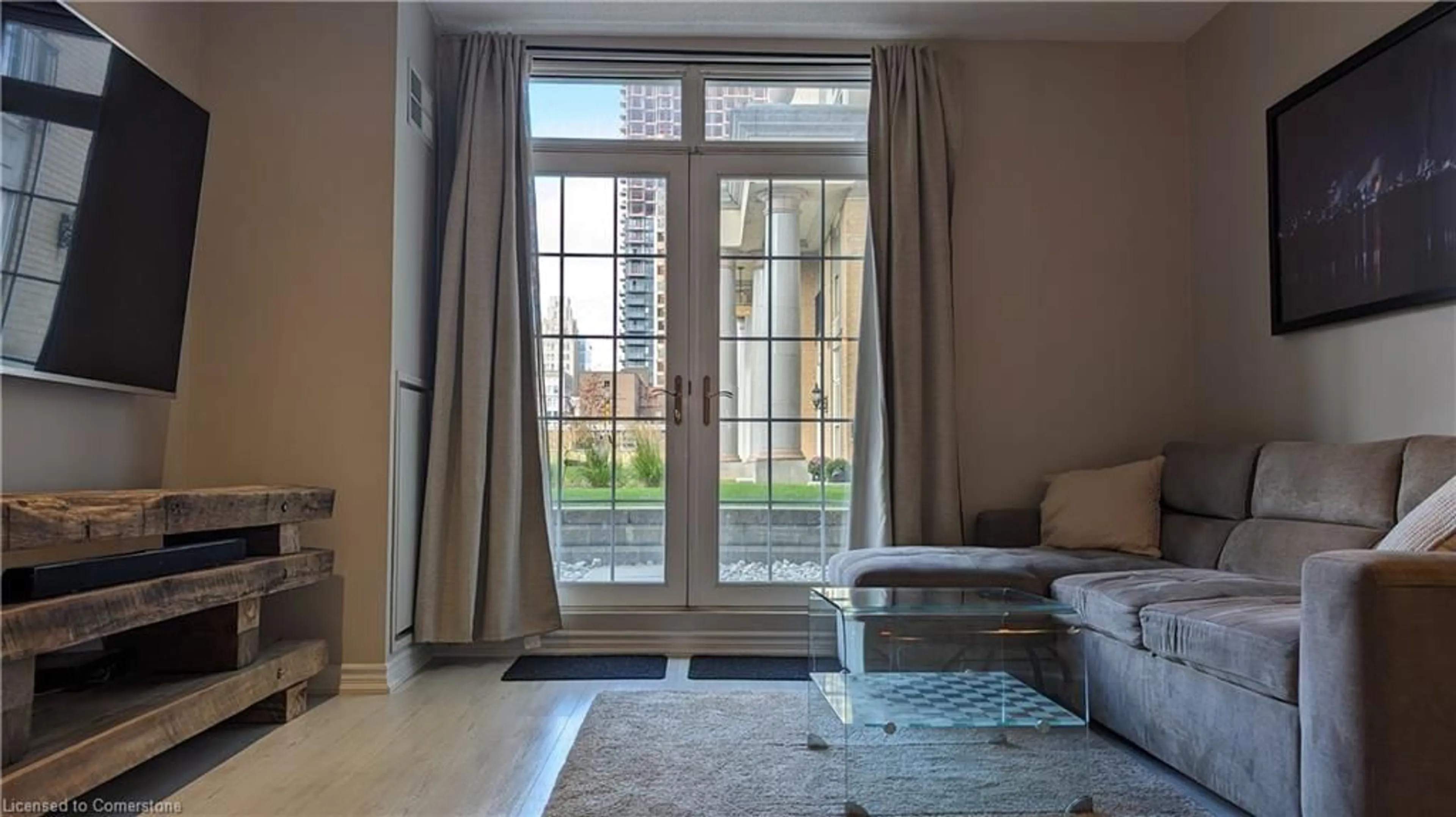 Living room with furniture, unknown for 135 James St #115, Hamilton Ontario L8P 2Z6