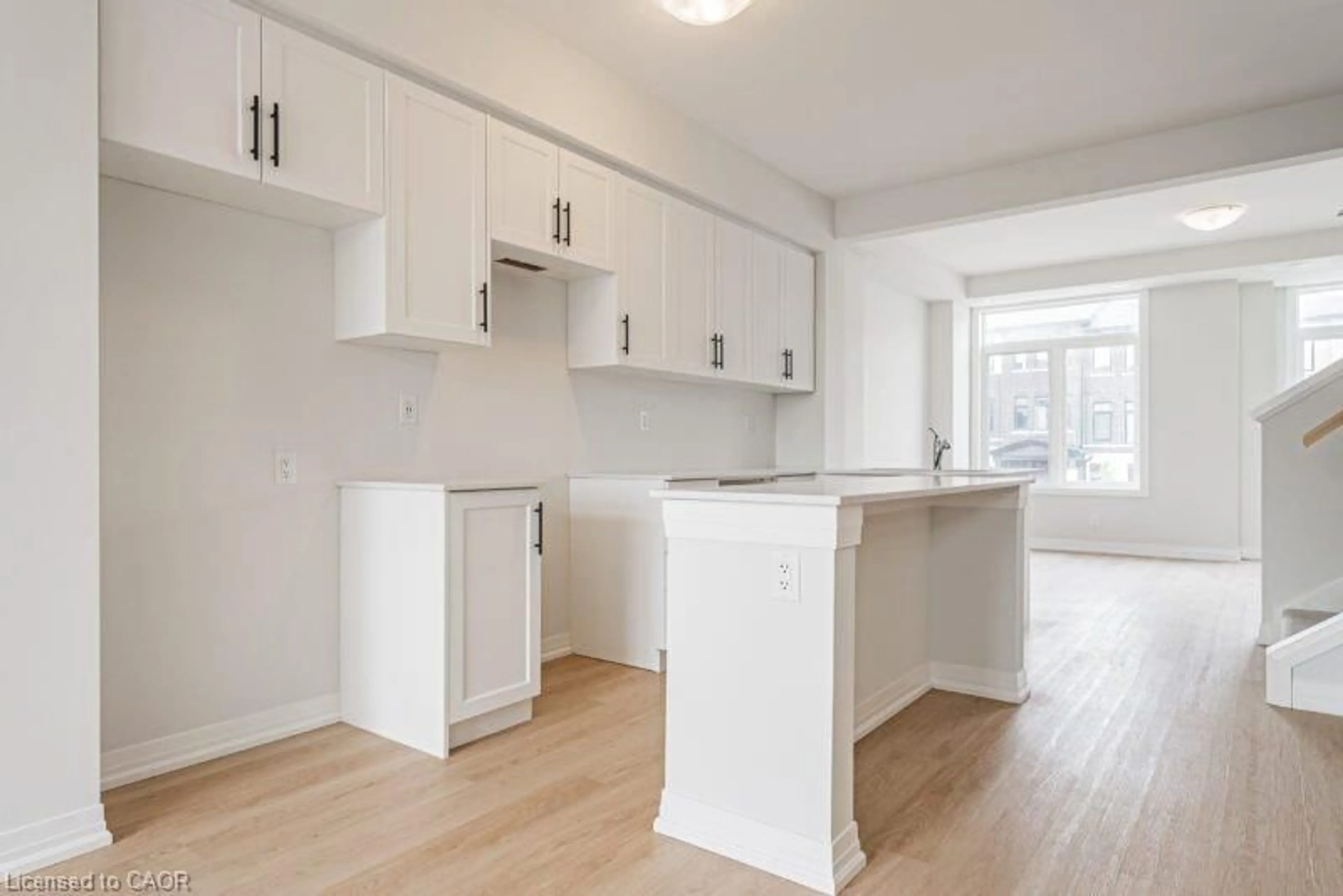 Open concept kitchen, wood/laminate floor for 155 Equestrian Way #22, Cambridge Ontario N3E 0E8