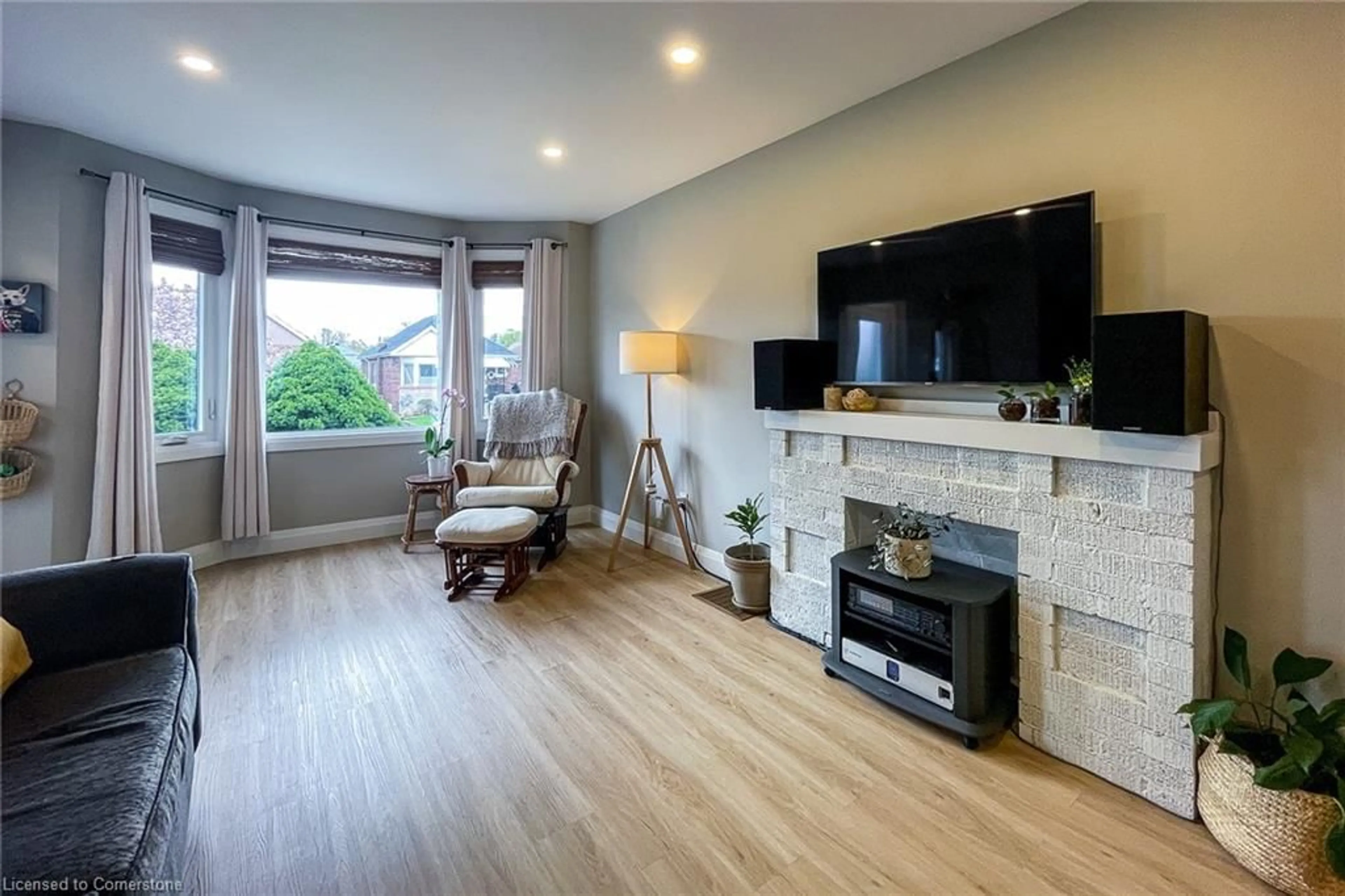Living room with furniture, wood/laminate floor for 112 Tragina Ave, Hamilton Ontario L8K 2Z6