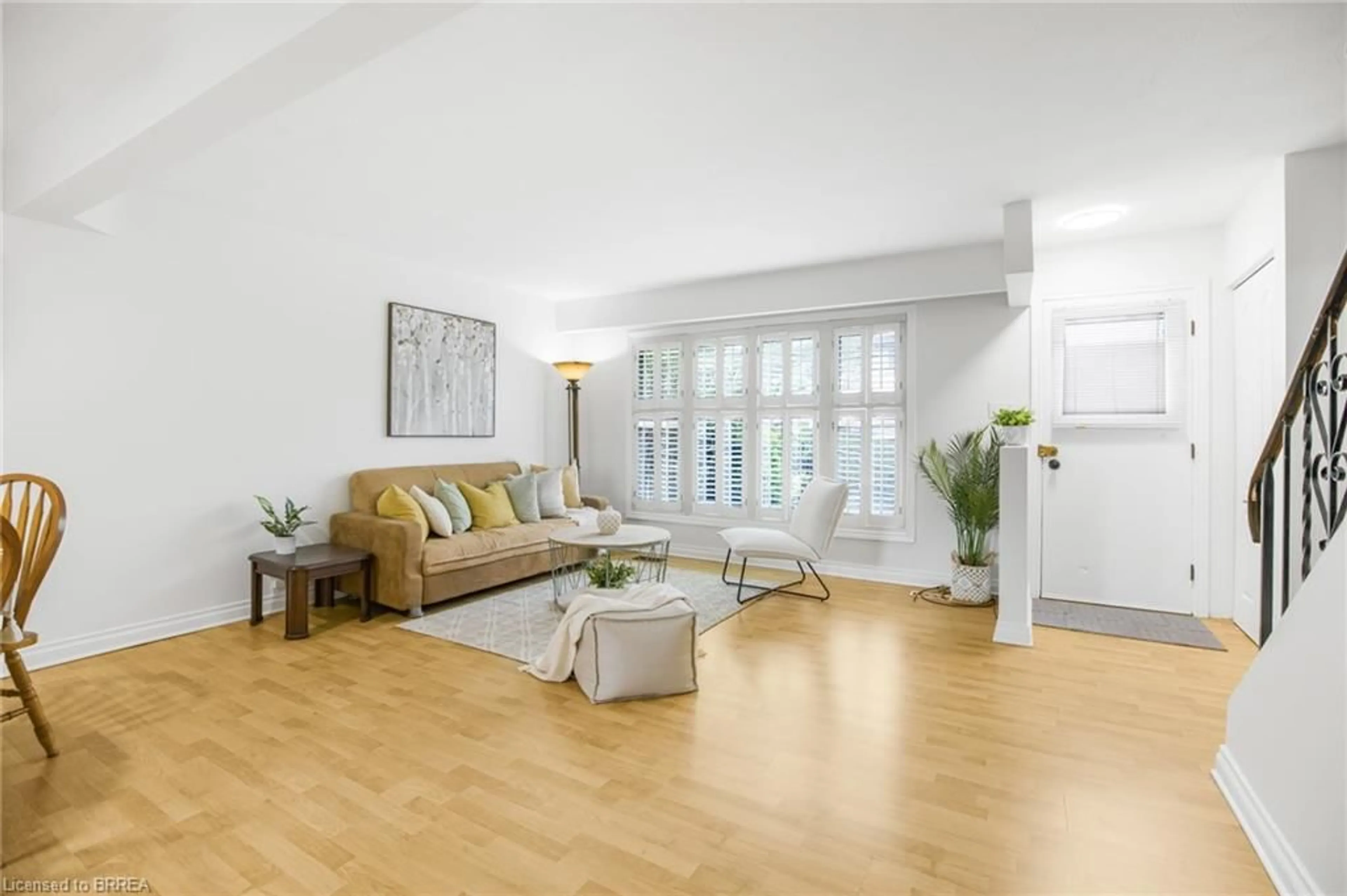 Living room with furniture, wood/laminate floor for 161 Berkindale Dr #5, Hamilton Ontario L8E 1M6