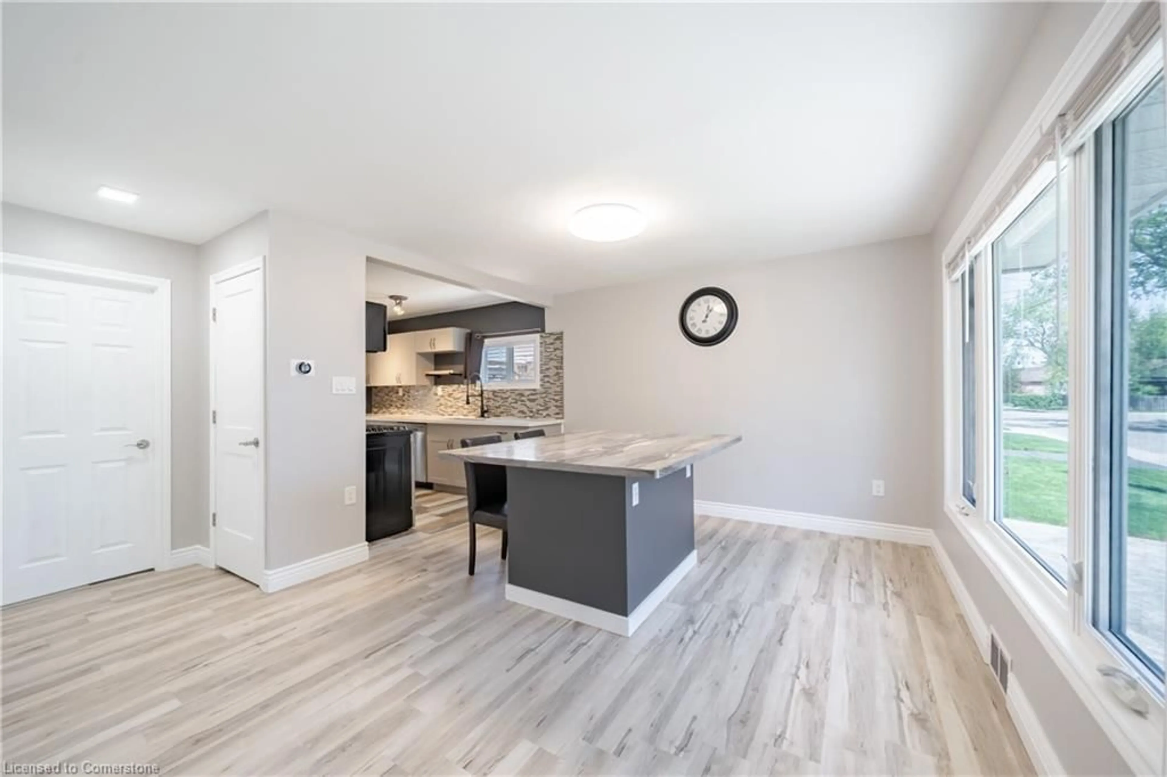 Open concept kitchen, wood/laminate floor for 109 Tolton Ave, Hamilton Ontario L8H 5N7
