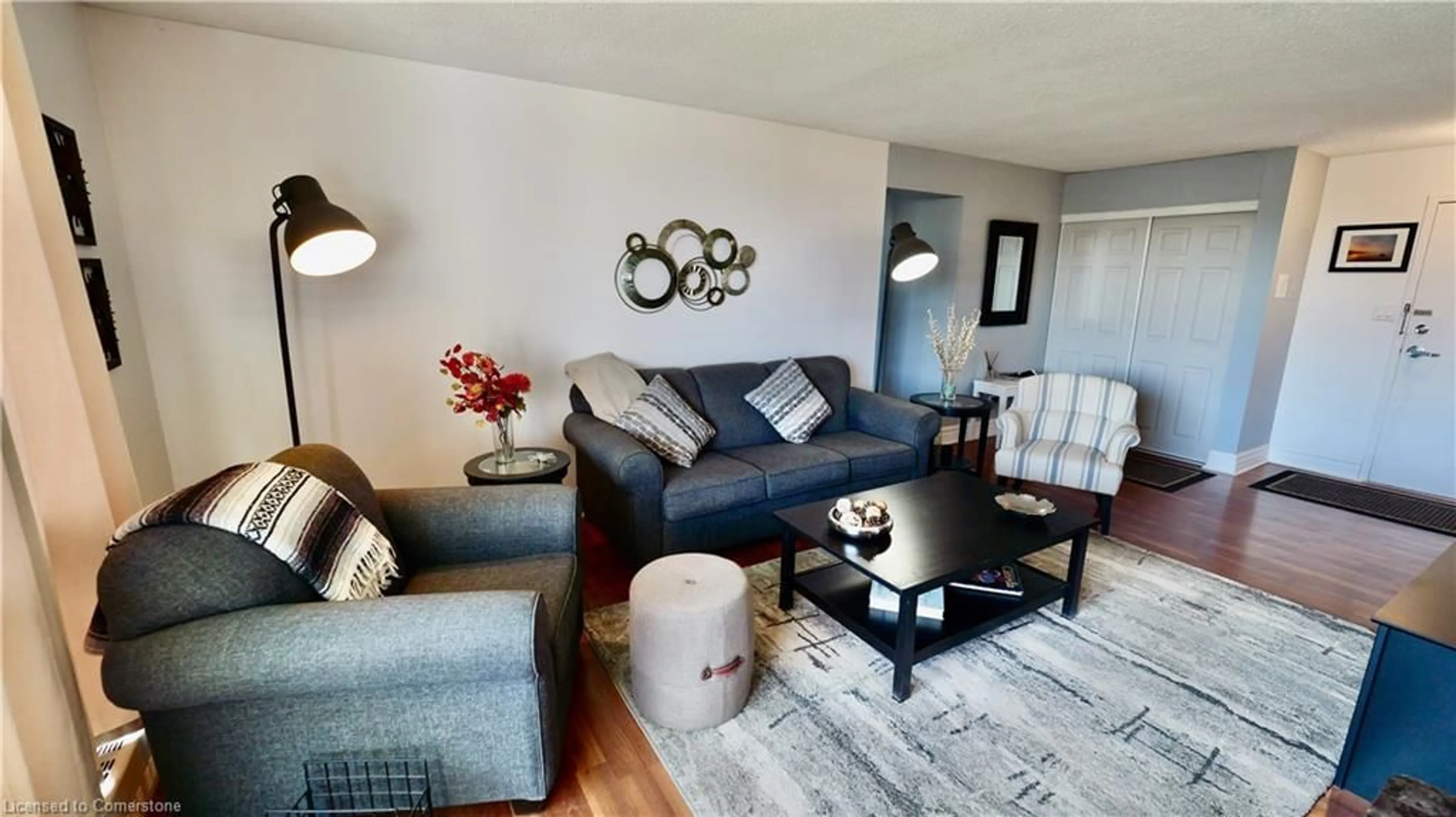 Living room with furniture, wood/laminate floor for 225 Harvard Pl #603, Waterloo Ontario N2J 4H4