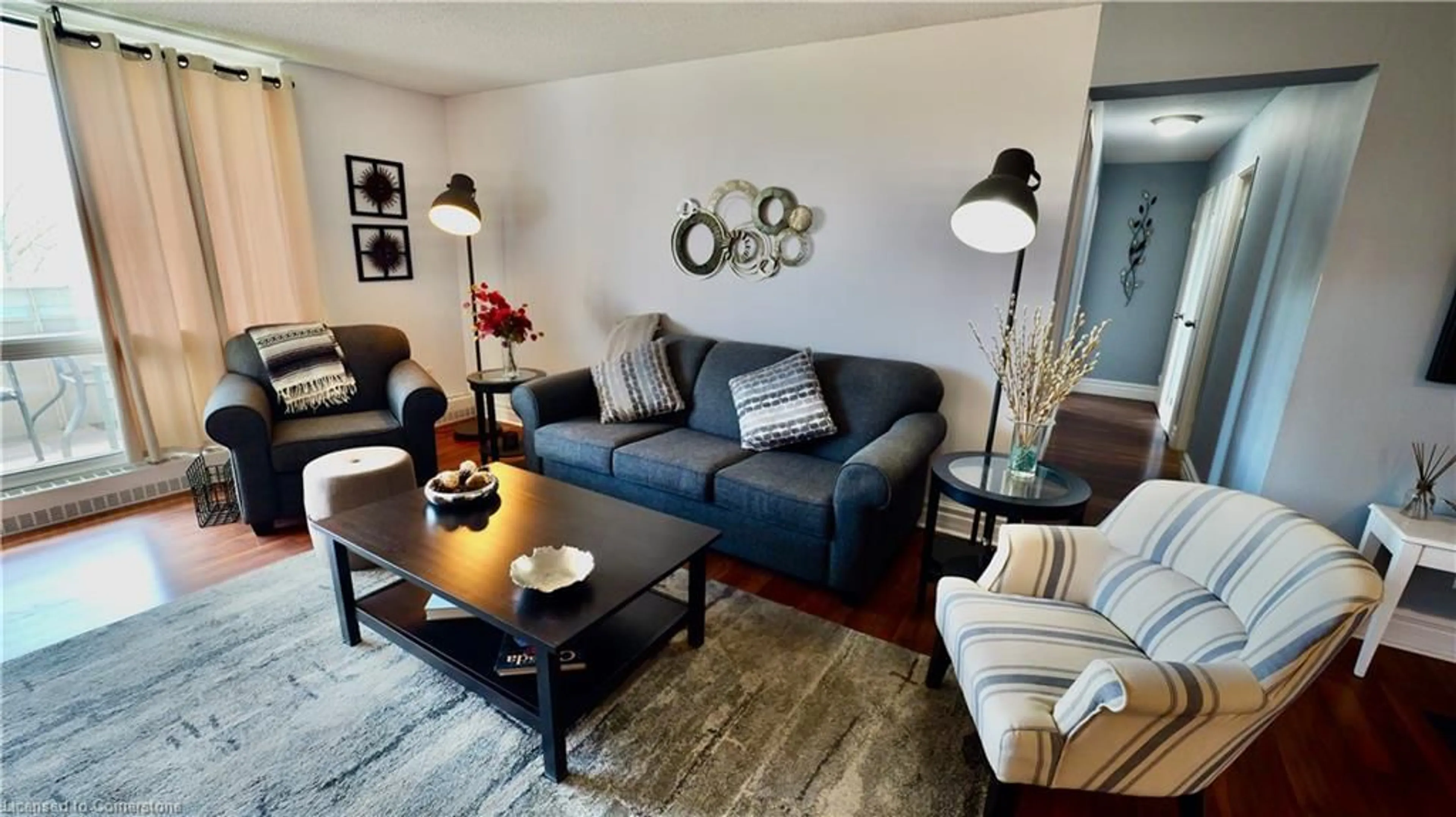 Living room with furniture, wood/laminate floor for 225 Harvard Pl #603, Waterloo Ontario N2J 4H4