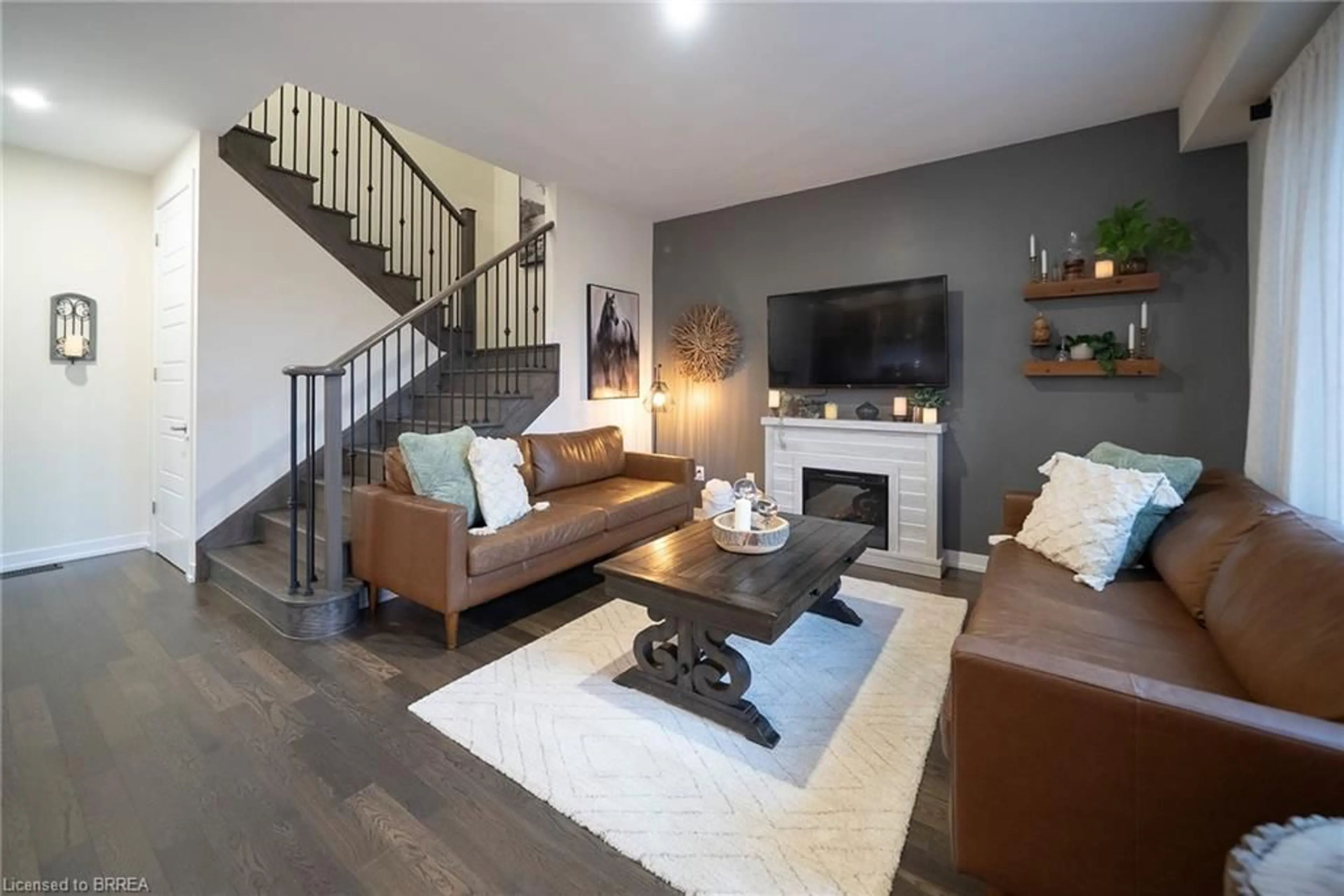 Living room with furniture, wood/laminate floor for 63 Santos Dr, Caledonia Ontario N3W 0H2