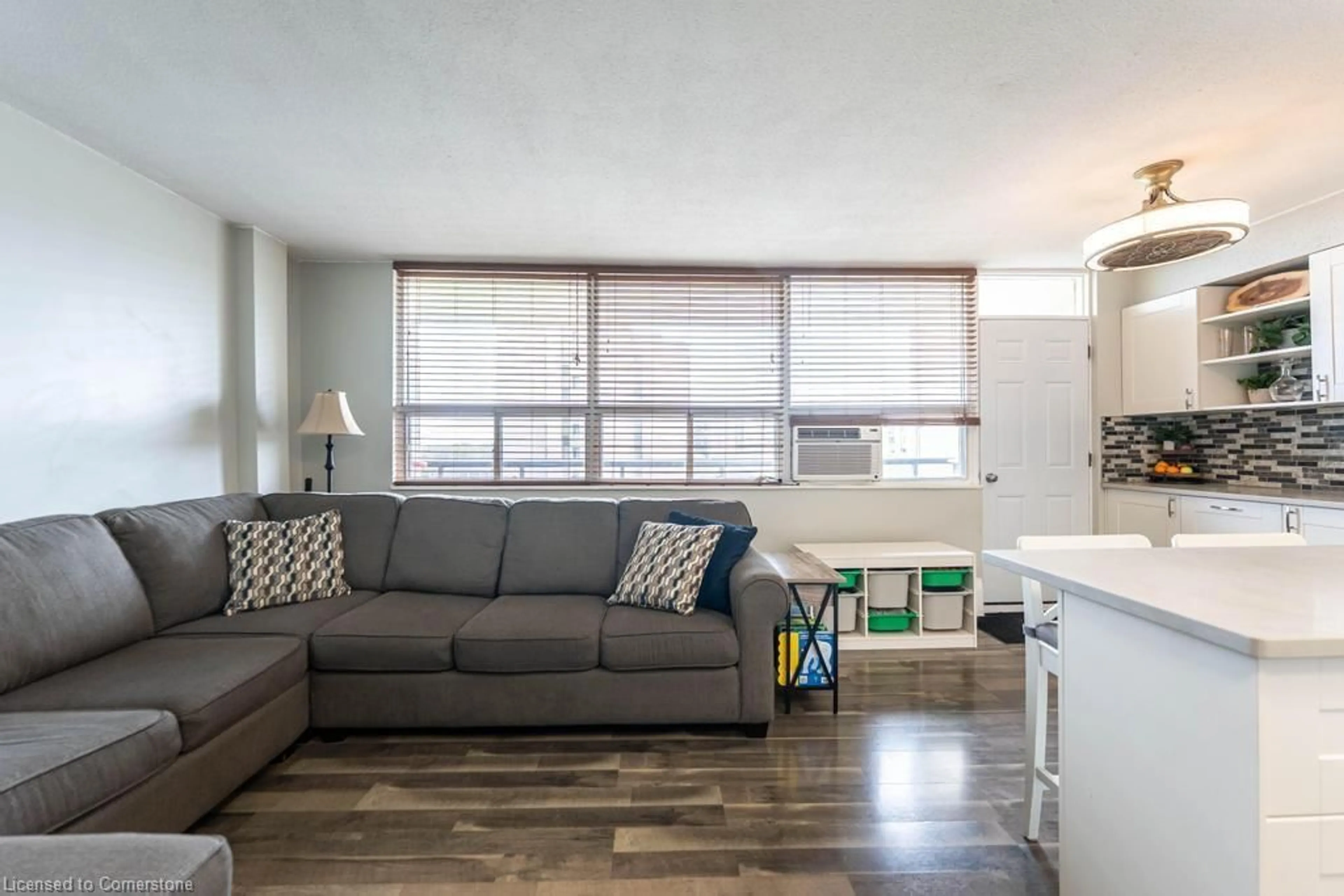 Living room with furniture, wood/laminate floor for 15 Nicklaus Dr #407, Hamilton Ontario L8K 5J5