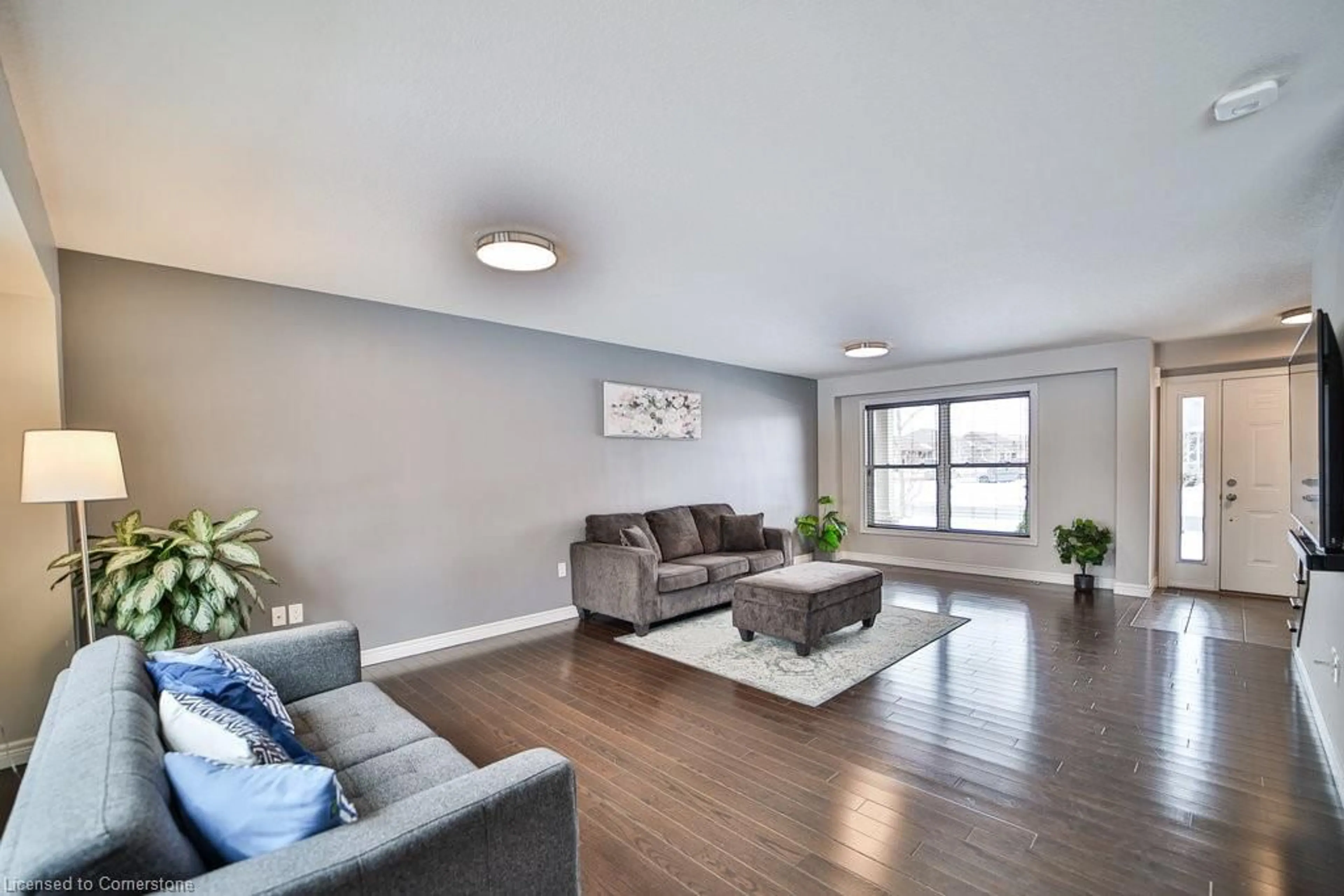 Living room with furniture, wood/laminate floor for 54 Harvest Gate, Smithville Ontario L0R 2A0