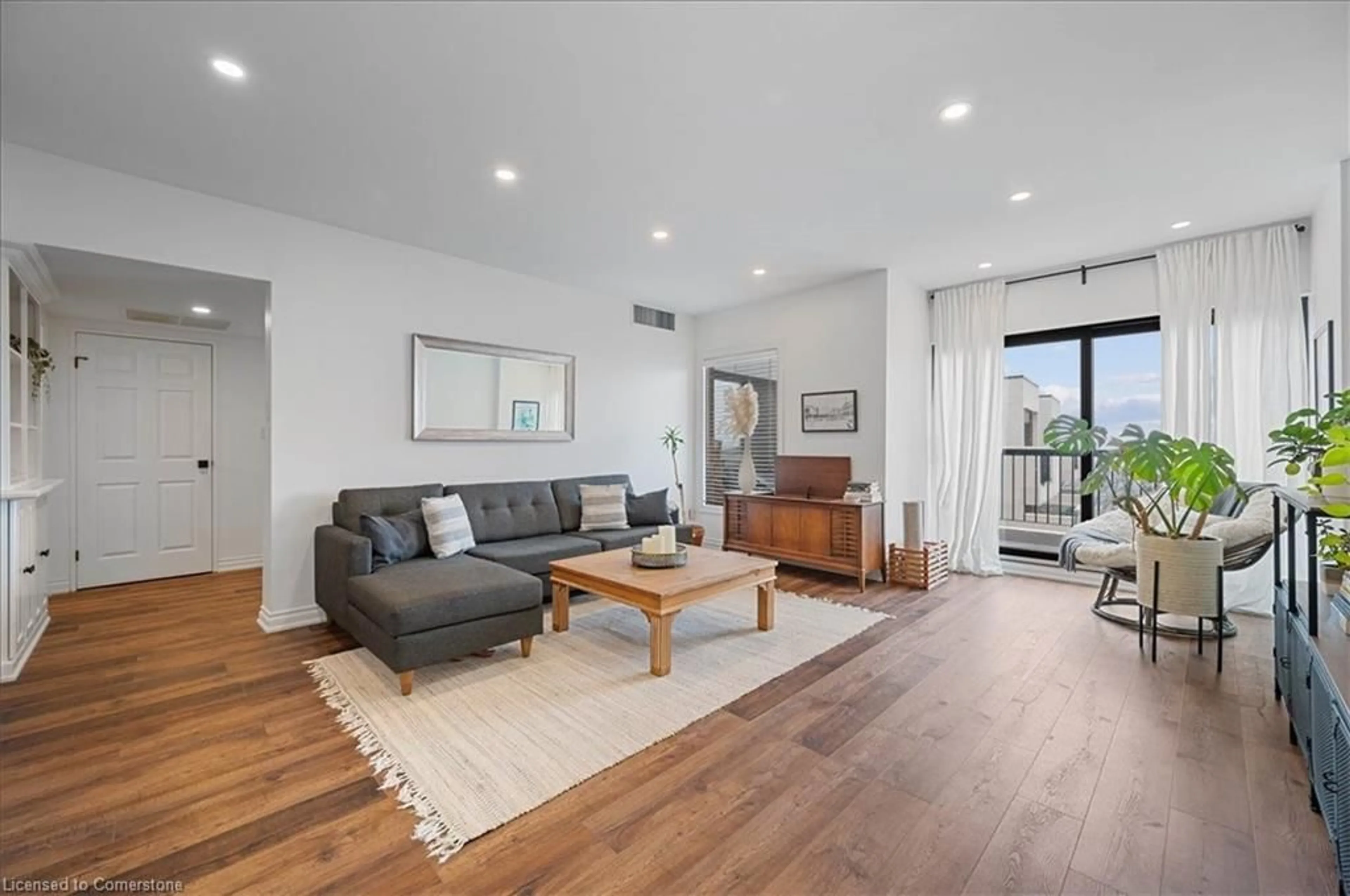 Living room with furniture, wood/laminate floor for 260 Sheldon Ave #809, Kitchener Ontario N2H 6P2