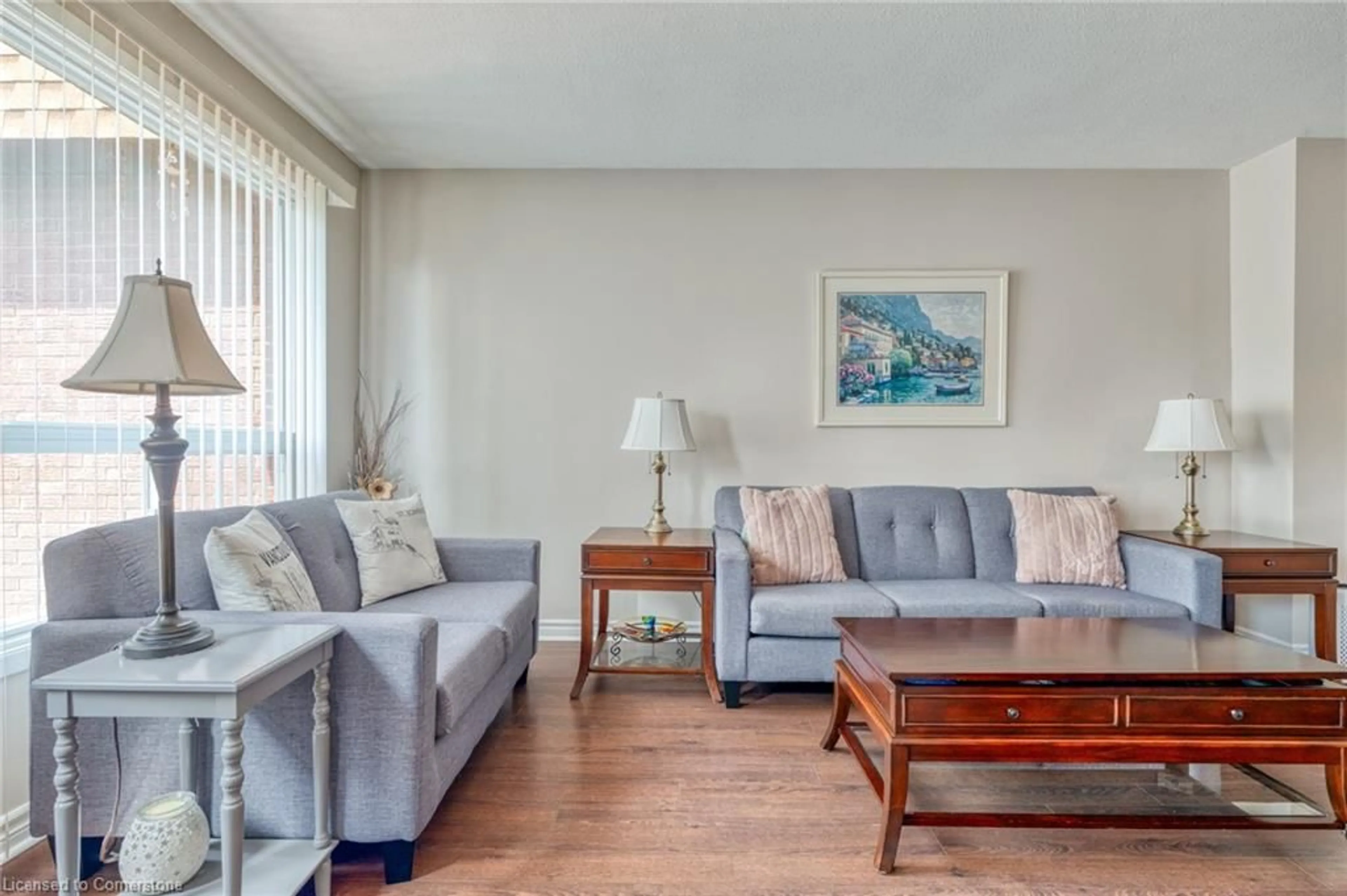 Living room with furniture, wood/laminate floor for 899 Stone Church Rd #2, Hamilton Ontario L8W 1B2