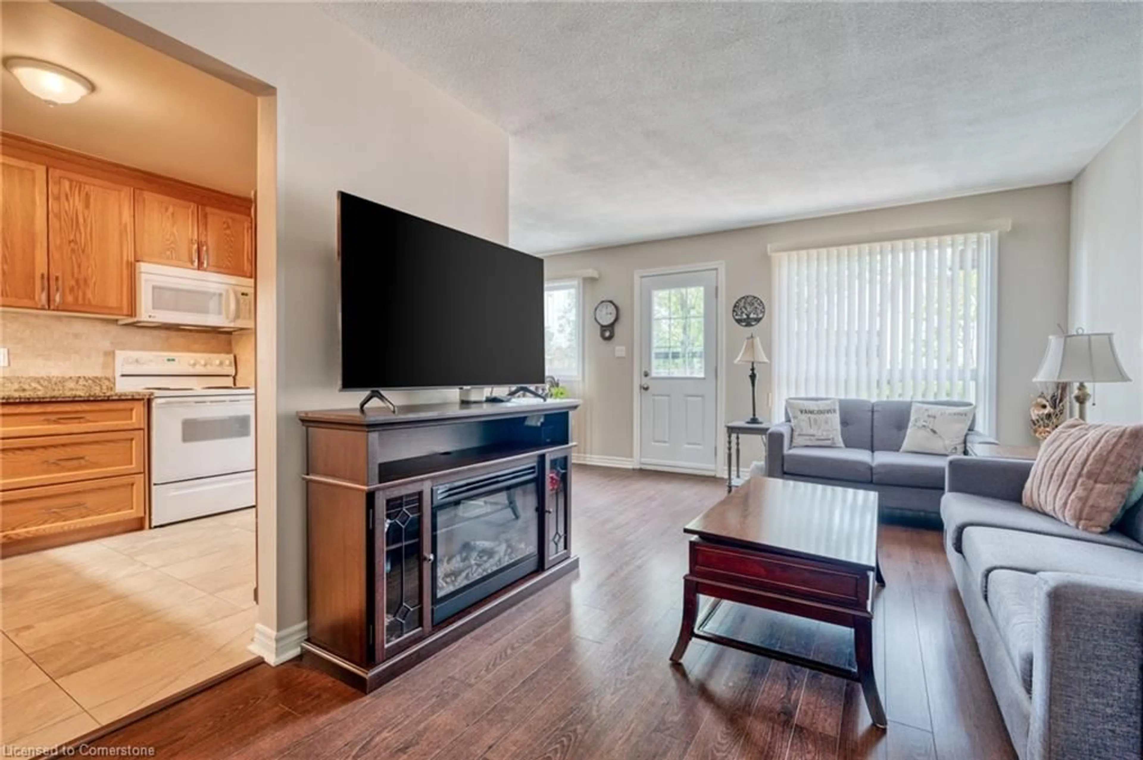 Living room with furniture, wood/laminate floor for 899 Stone Church Rd #2, Hamilton Ontario L8W 1B2