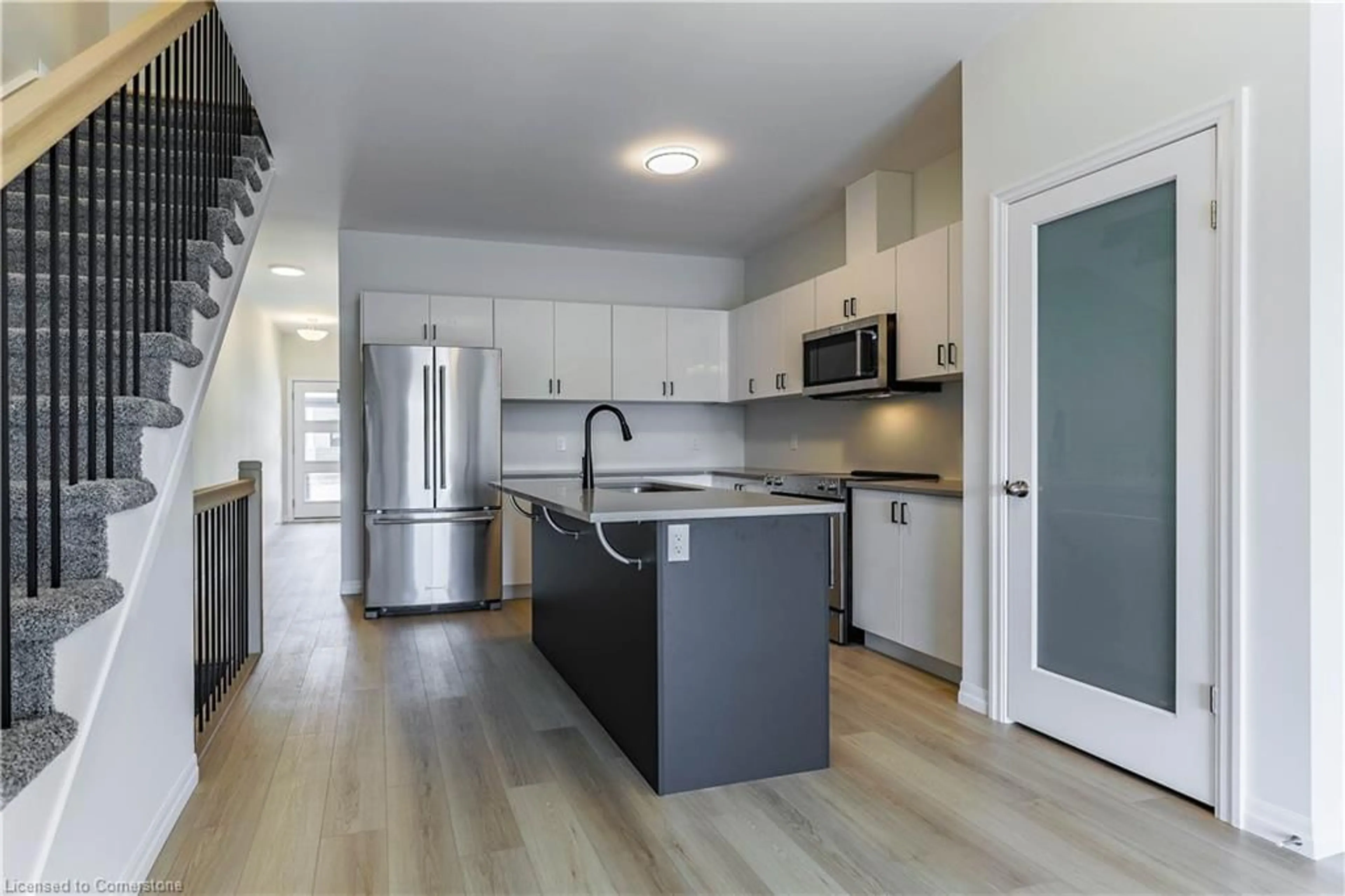 Open concept kitchen, wood/laminate floor for 61 Barn Owl Way, Simcoe Ontario N3Y 0H4