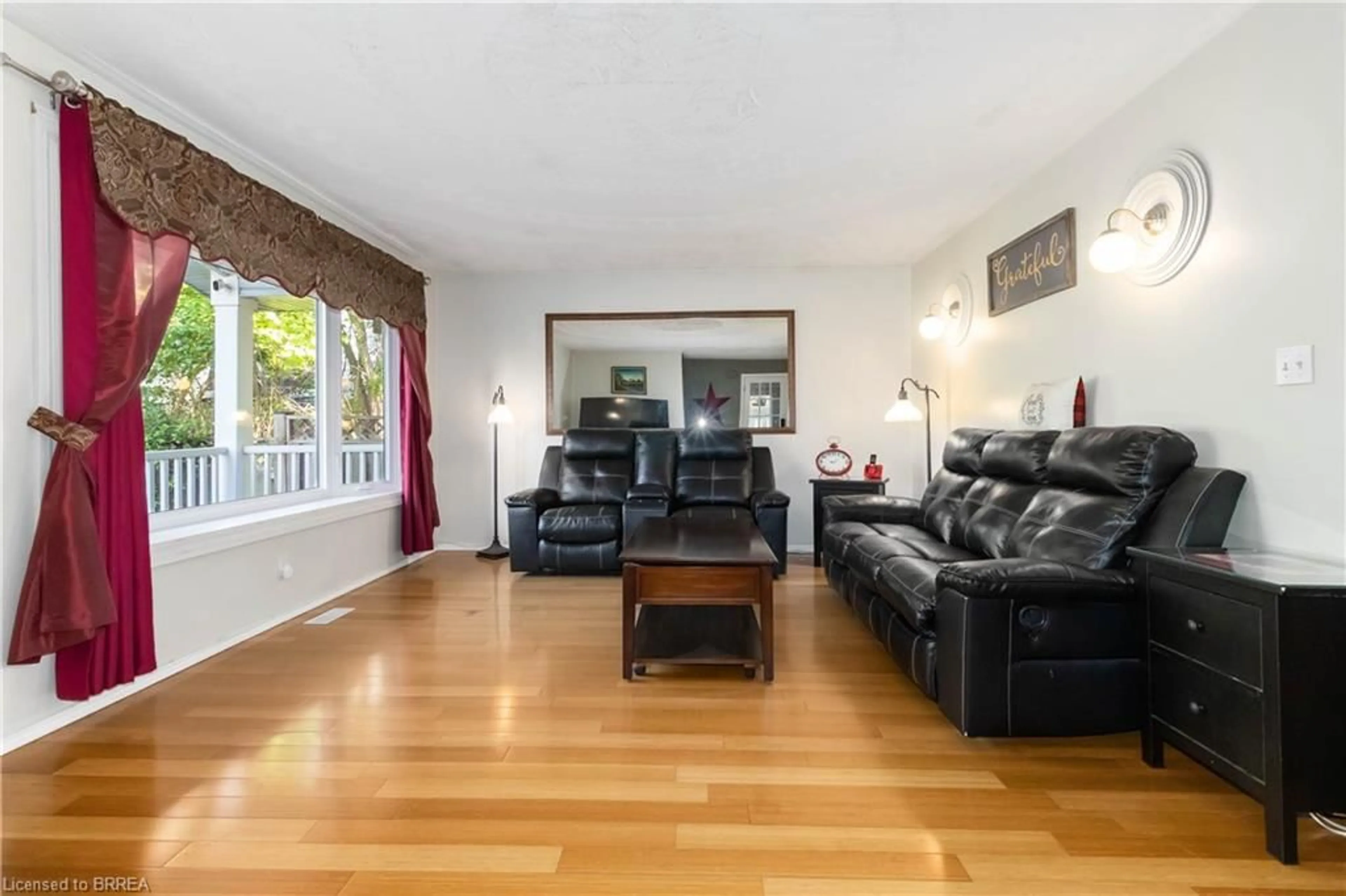 Living room with furniture, wood/laminate floor for 83 Locks Rd, Brantford Ontario N3S 7L9