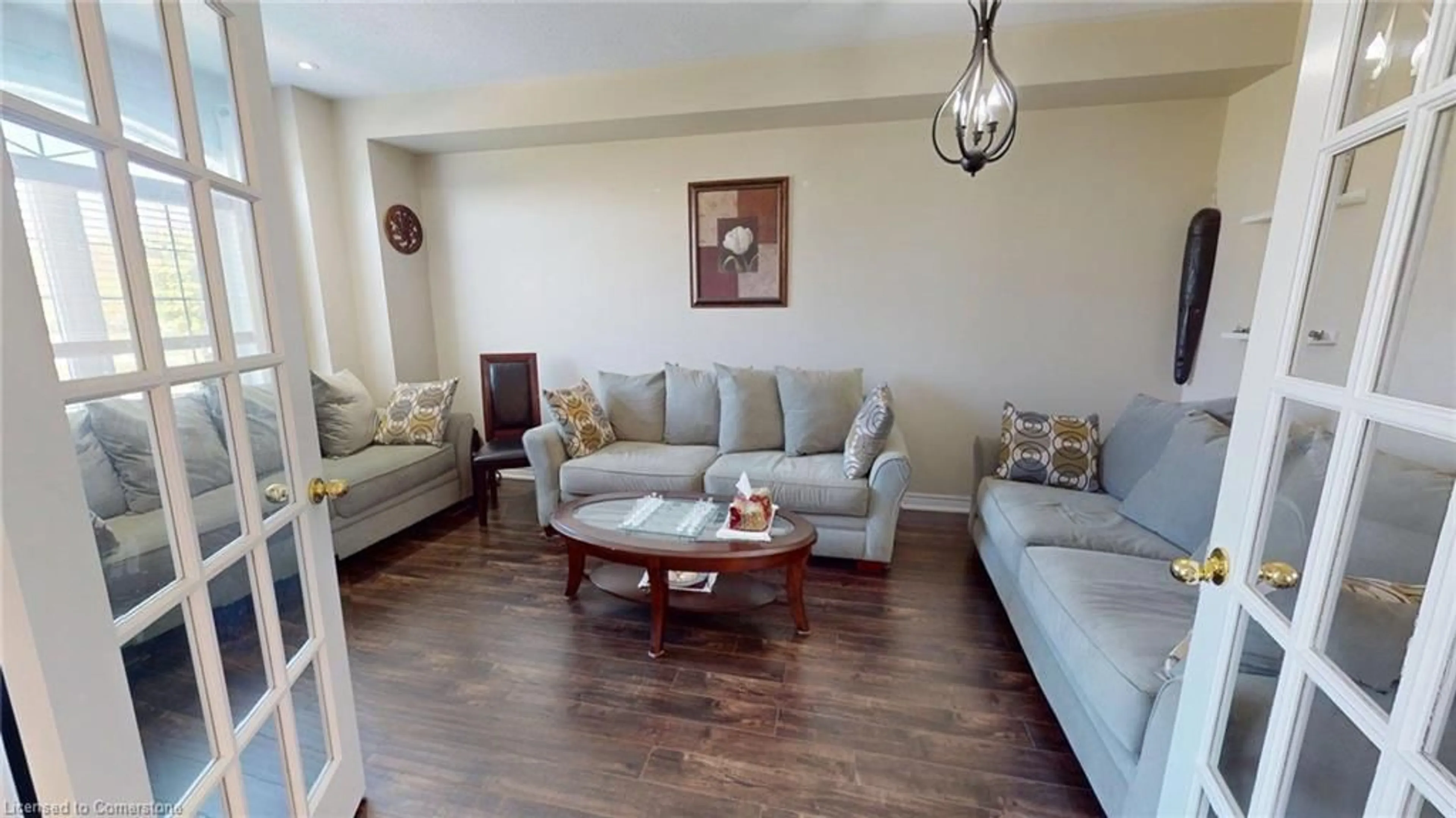 Living room with furniture, wood/laminate floor for 206 Springstead Ave, Stoney Creek Ontario L8E 6E8
