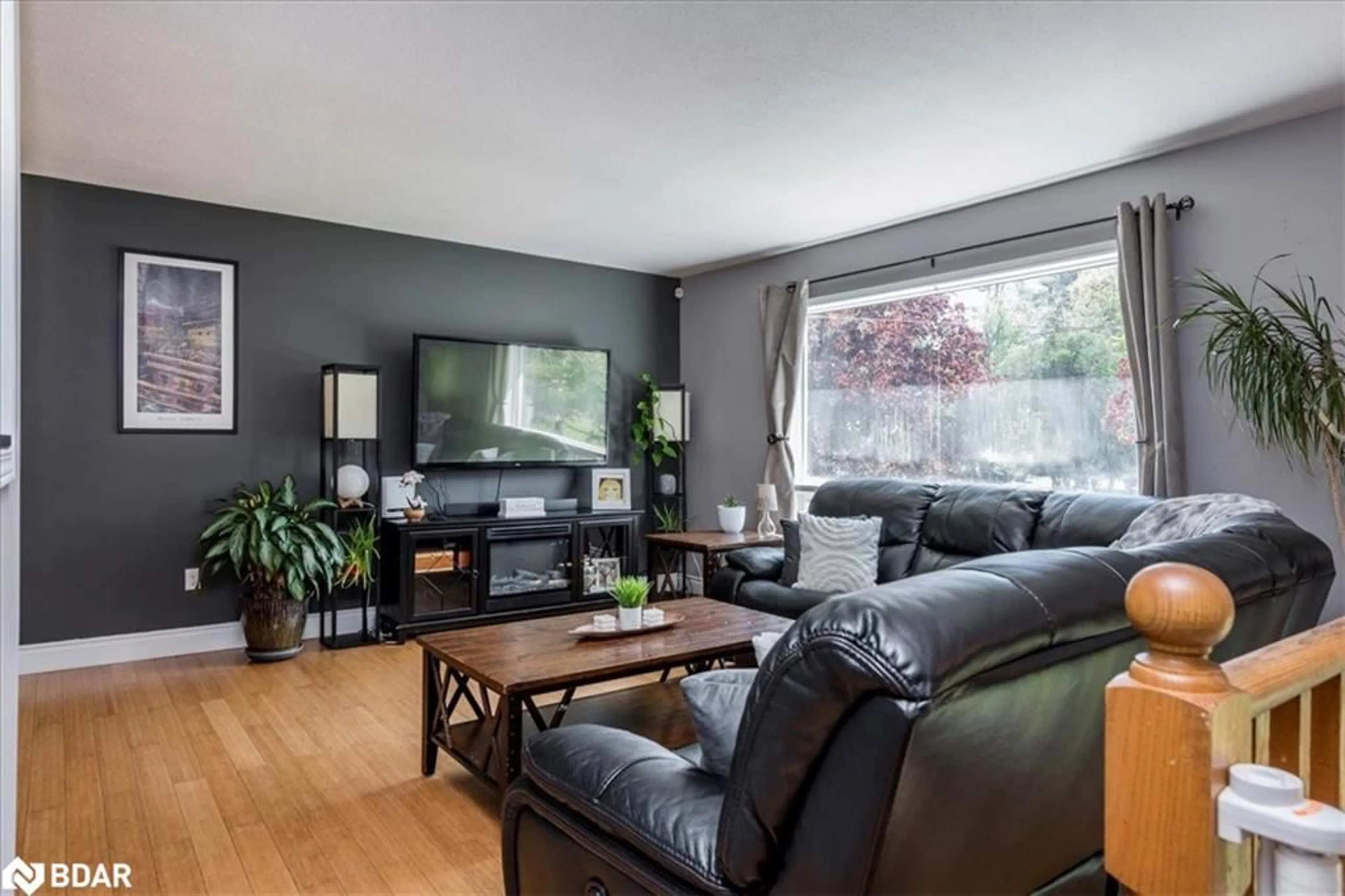 Living room with furniture, wood/laminate floor for 3974 Horseshoe Valley Rd, Anten Mills Ontario L0L 1Y0