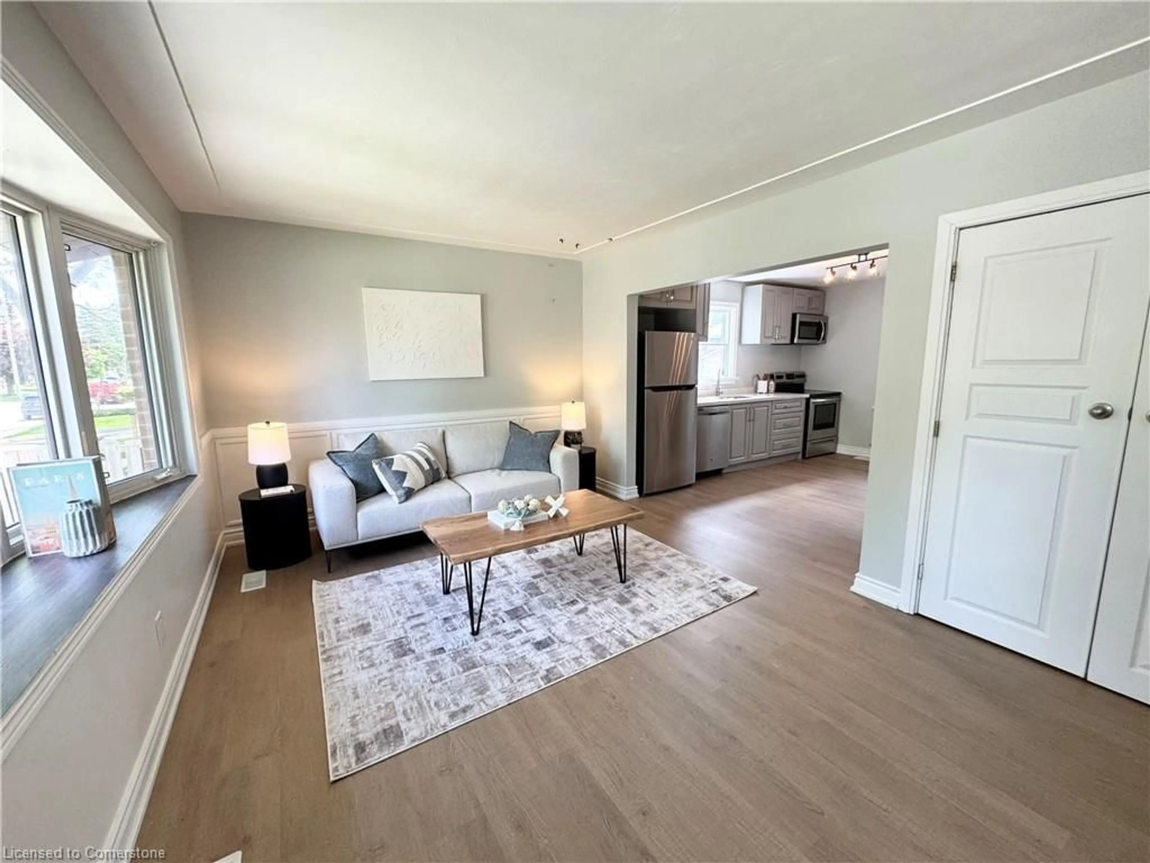 Living room with furniture, wood/laminate floor for 26 Grandfield St, Hamilton Ontario L8T 2H2
