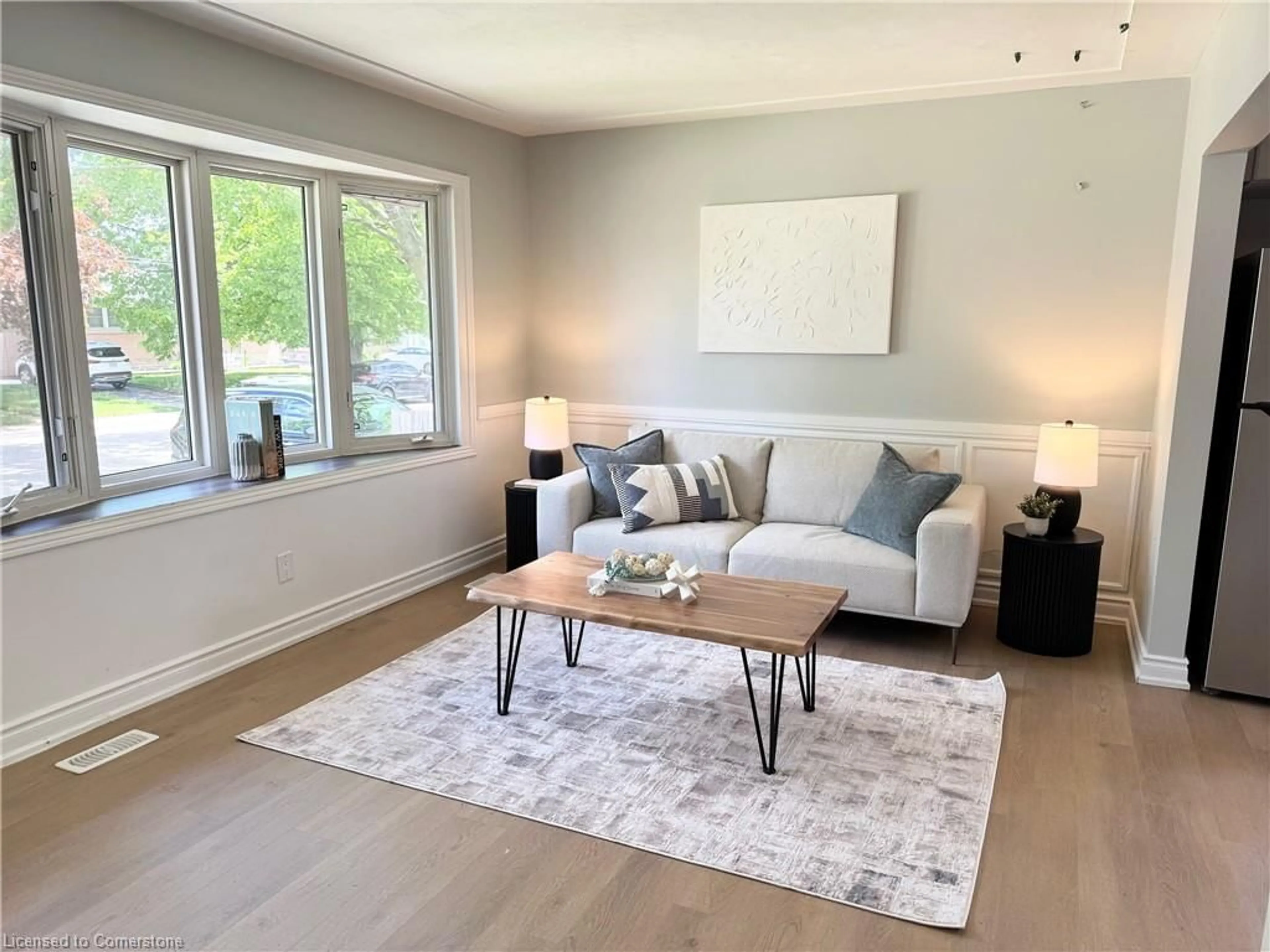 Living room with furniture, wood/laminate floor for 26 Grandfield St, Hamilton Ontario L8T 2H2