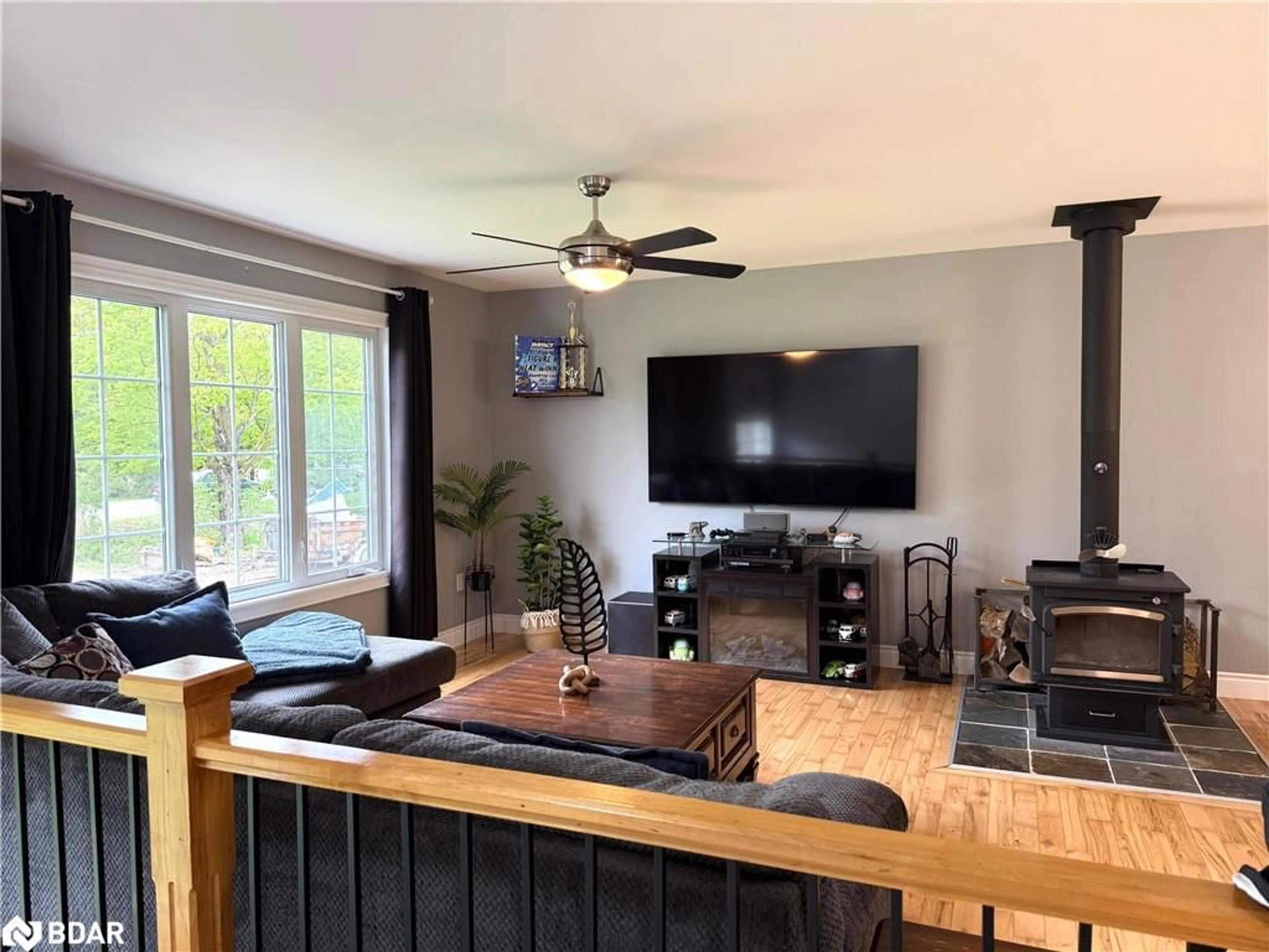 Living room with furniture, wood/laminate floor for 402187 County Road 15, Grand Valley Ontario L9W 3B5