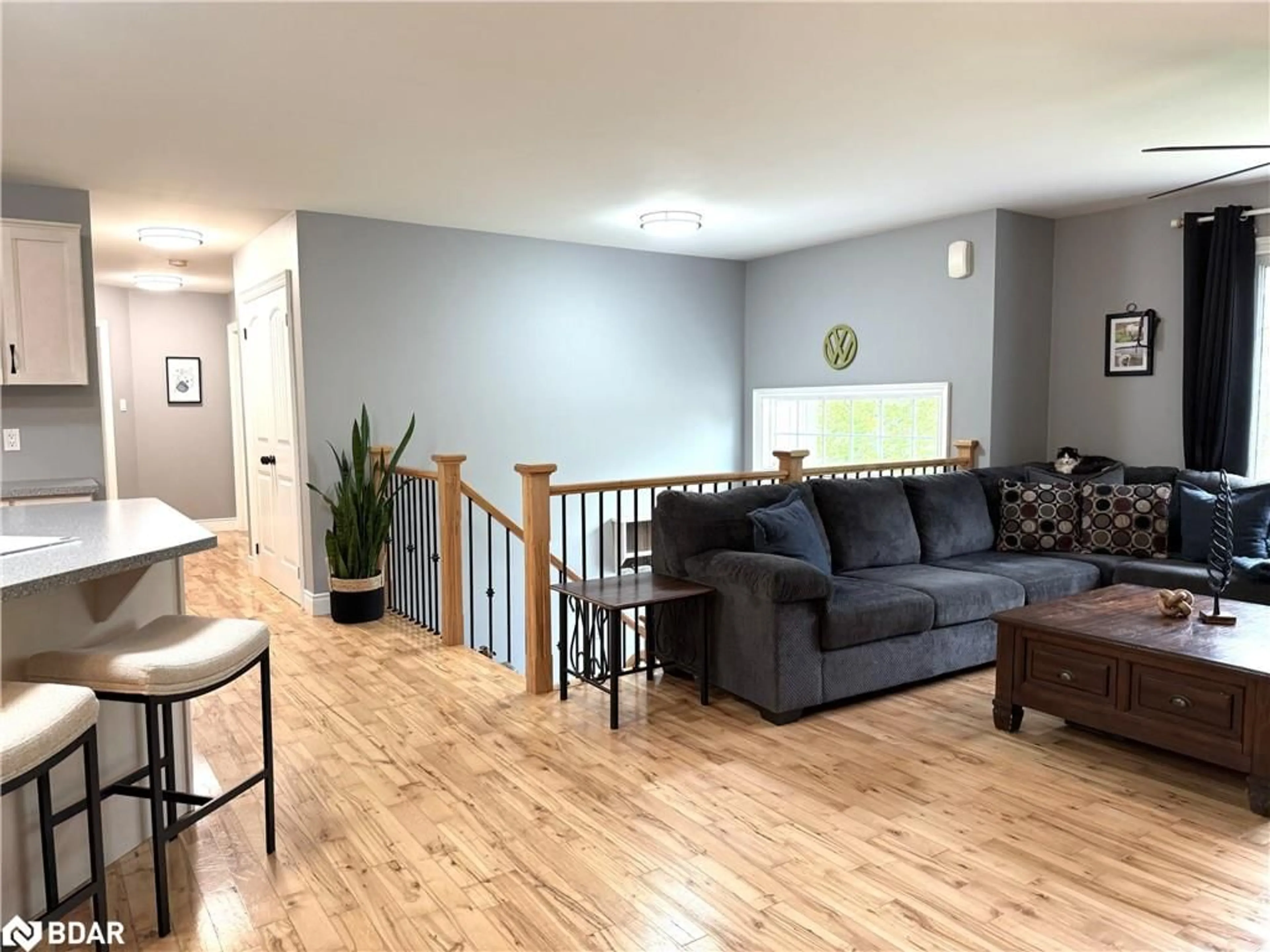 Living room with furniture, wood/laminate floor for 402187 County Road 15, Grand Valley Ontario L9W 3B5