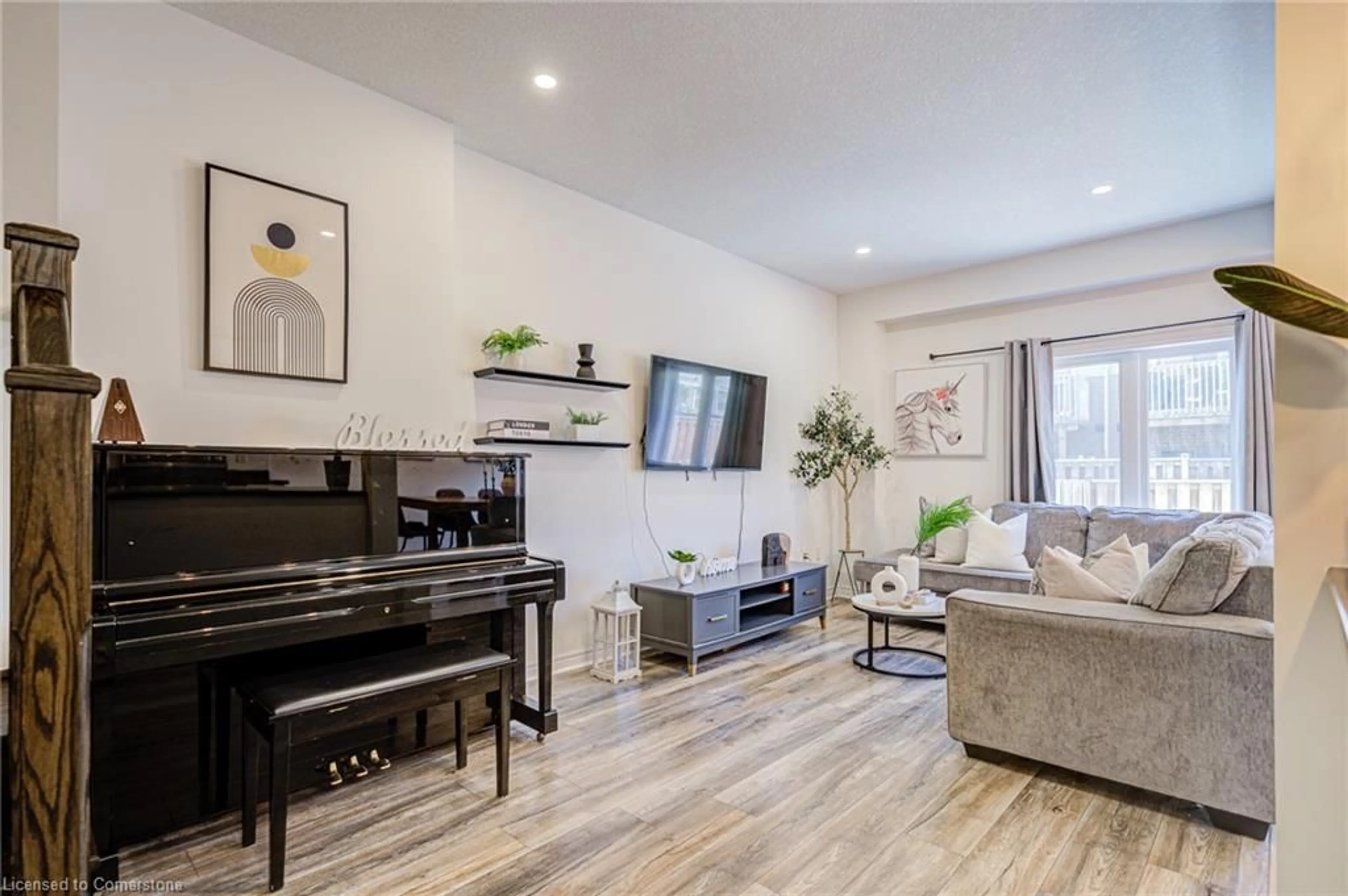 Living room with furniture, wood/laminate floor for 31 Garlent Ave, Hamilton Ontario L9K 0J9