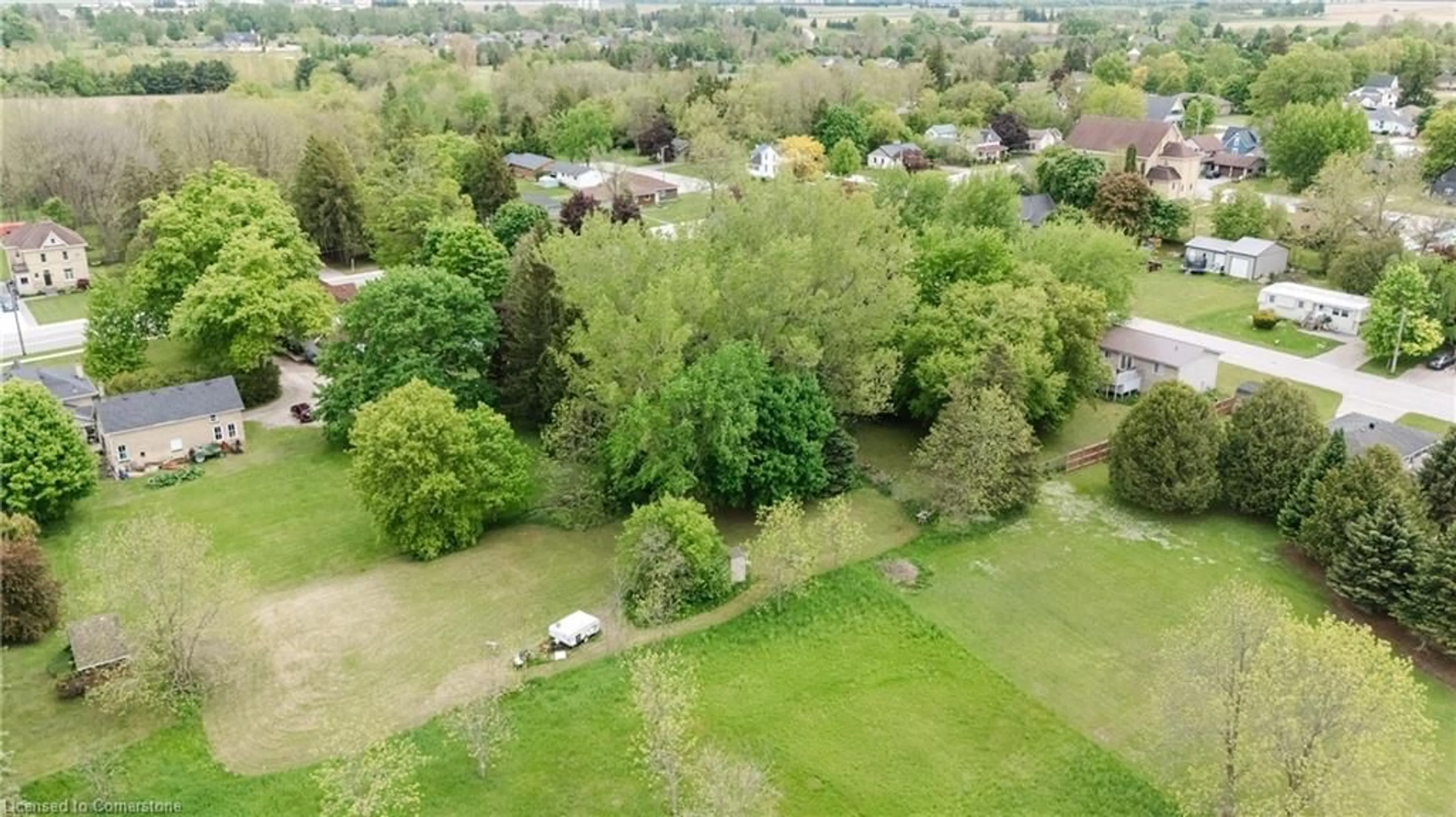 A pic from outside/outdoor area/front of a property/back of a property/a pic from drone, forest/trees view for 25 North St, Egmondville Ontario N0K 1G0