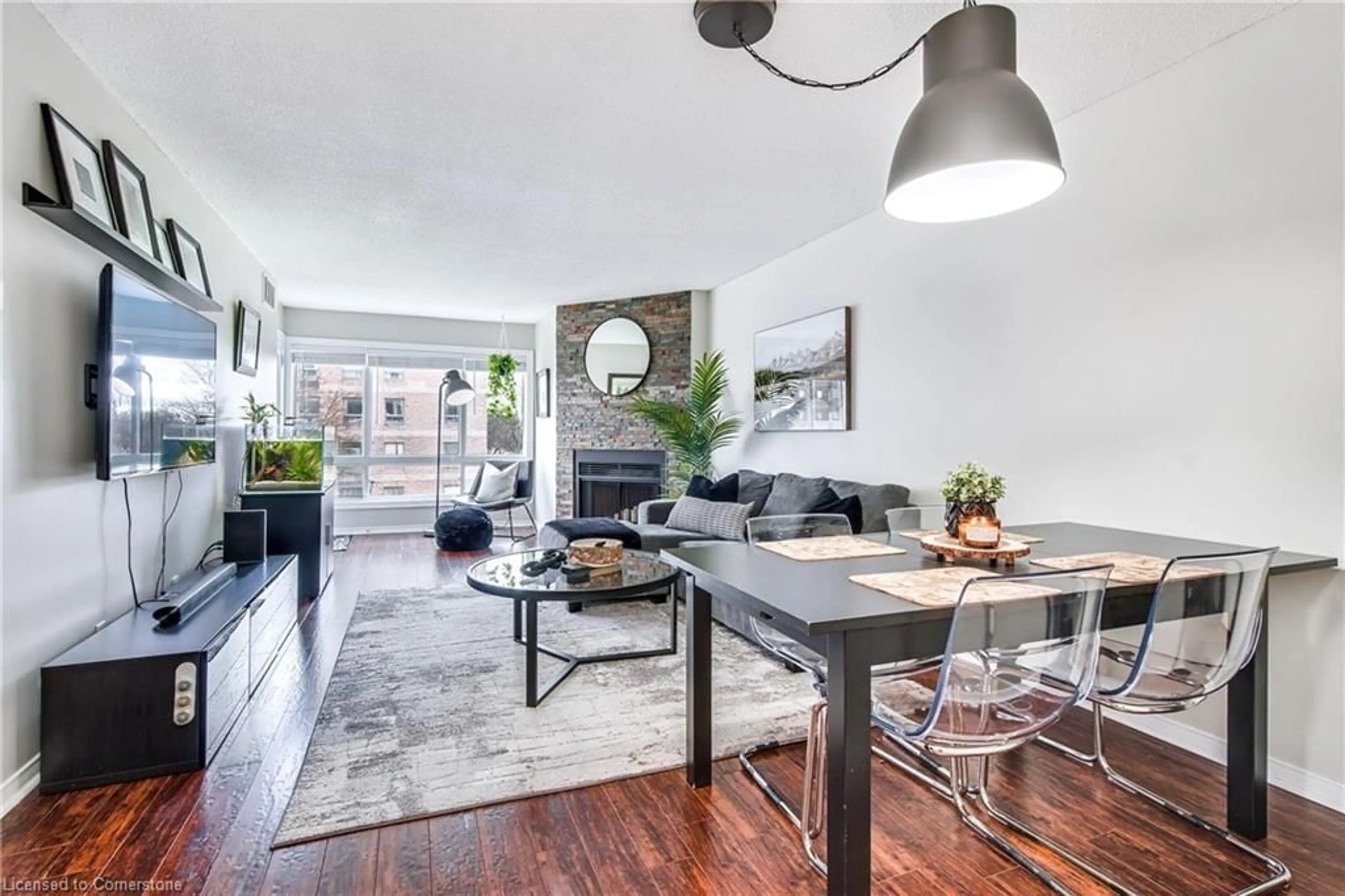 Living room with furniture, wood/laminate floor for 78 Roehampton Ave #317, St. Catharines Ontario L2M 7W9