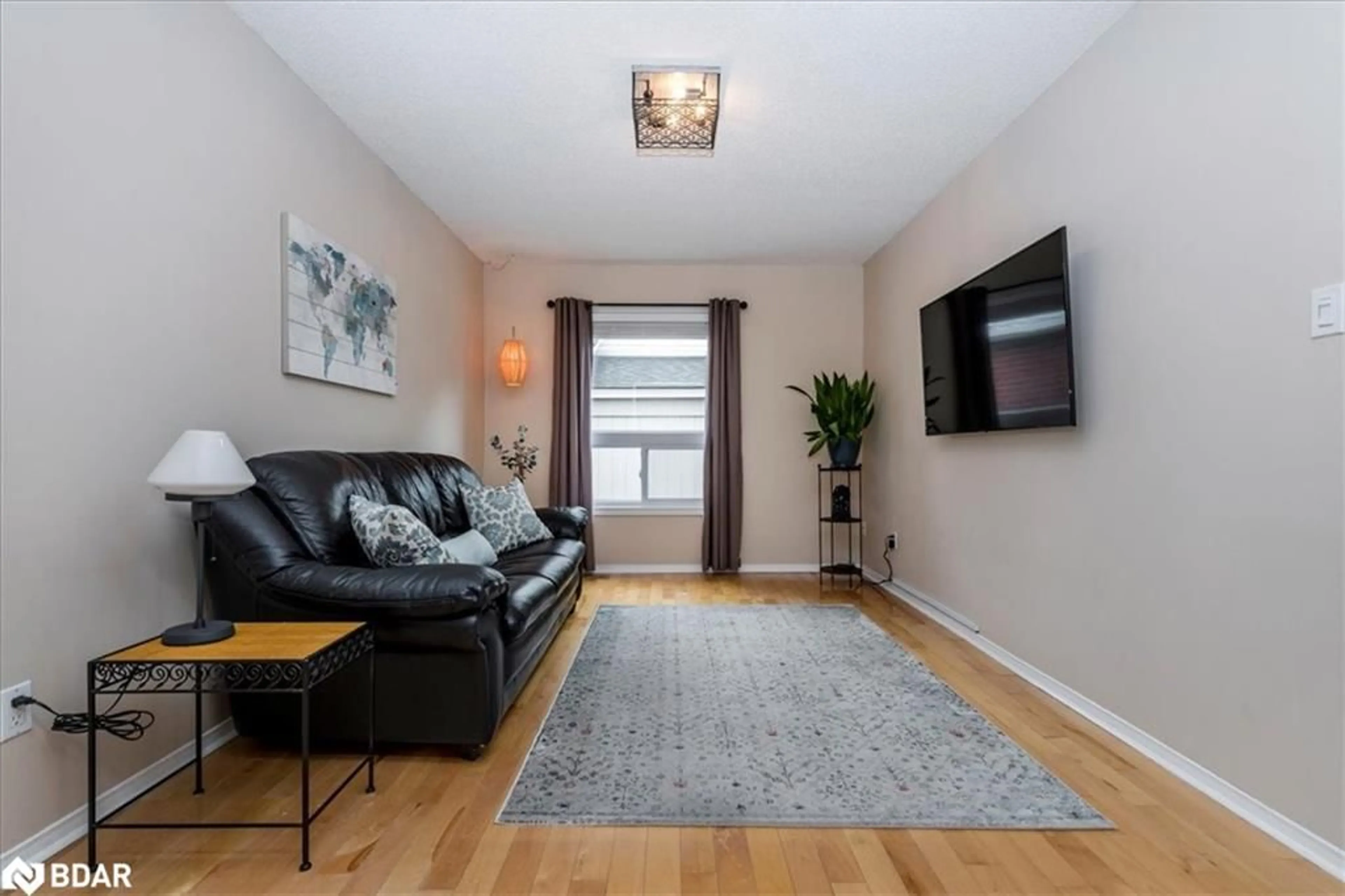 Living room with furniture, wood/laminate floor for 472 Haines St, Beeton Ontario L0G 1A0
