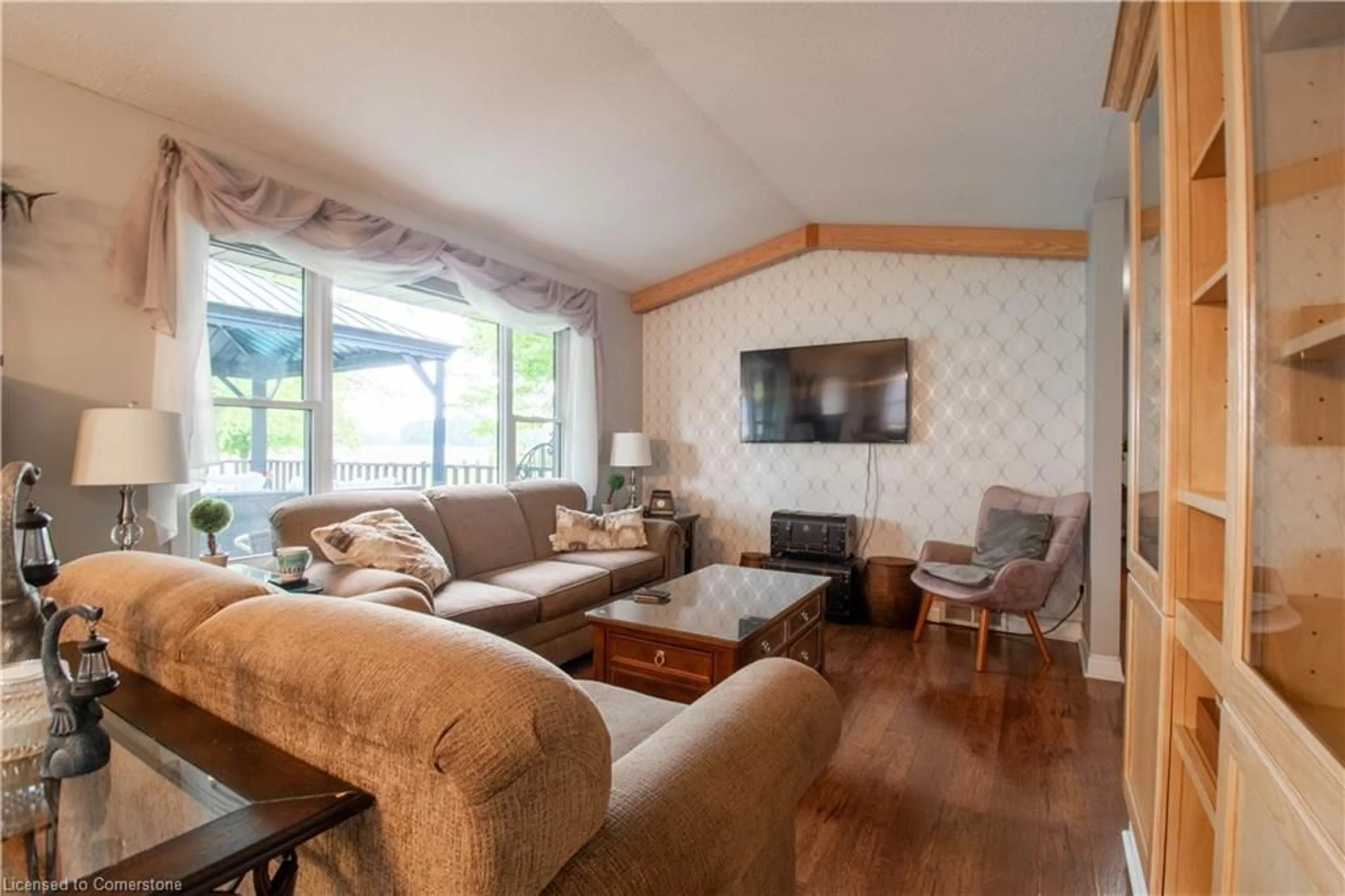 Living room with furniture, wood/laminate floor for 56057 Heritage Line, Straffordville Ontario N0J 1Y0