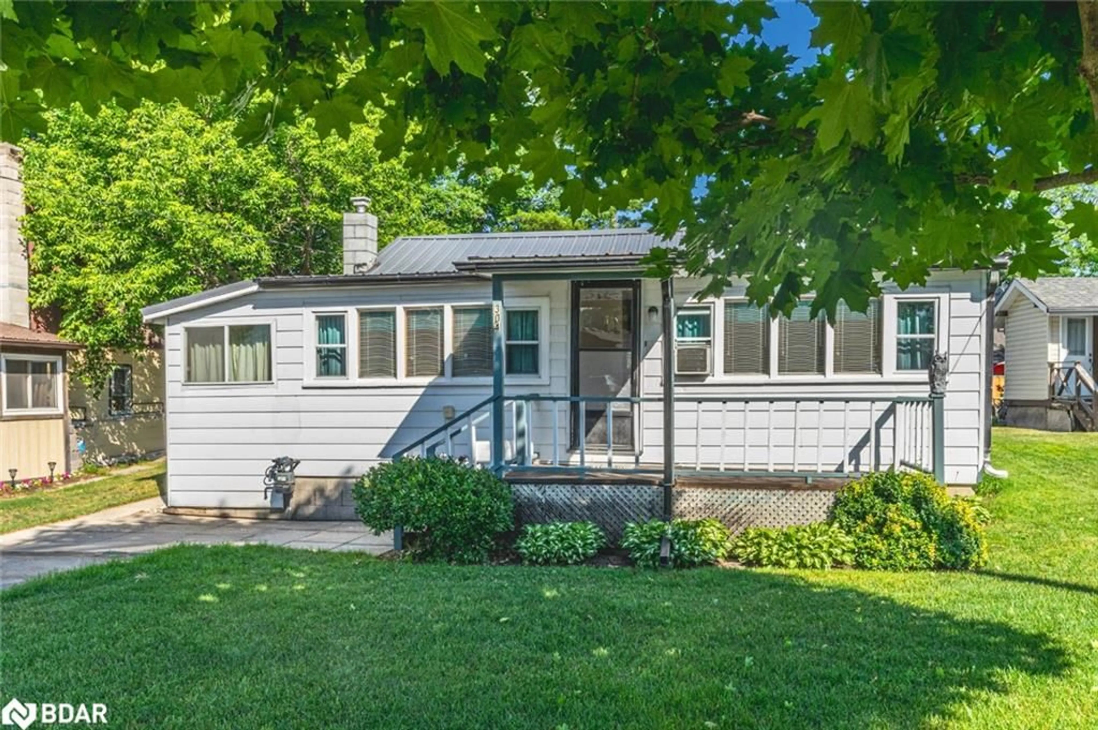 Home with vinyl exterior material, street for 304 Old Mosley St, Wasaga Beach Ontario L9Z 2J8
