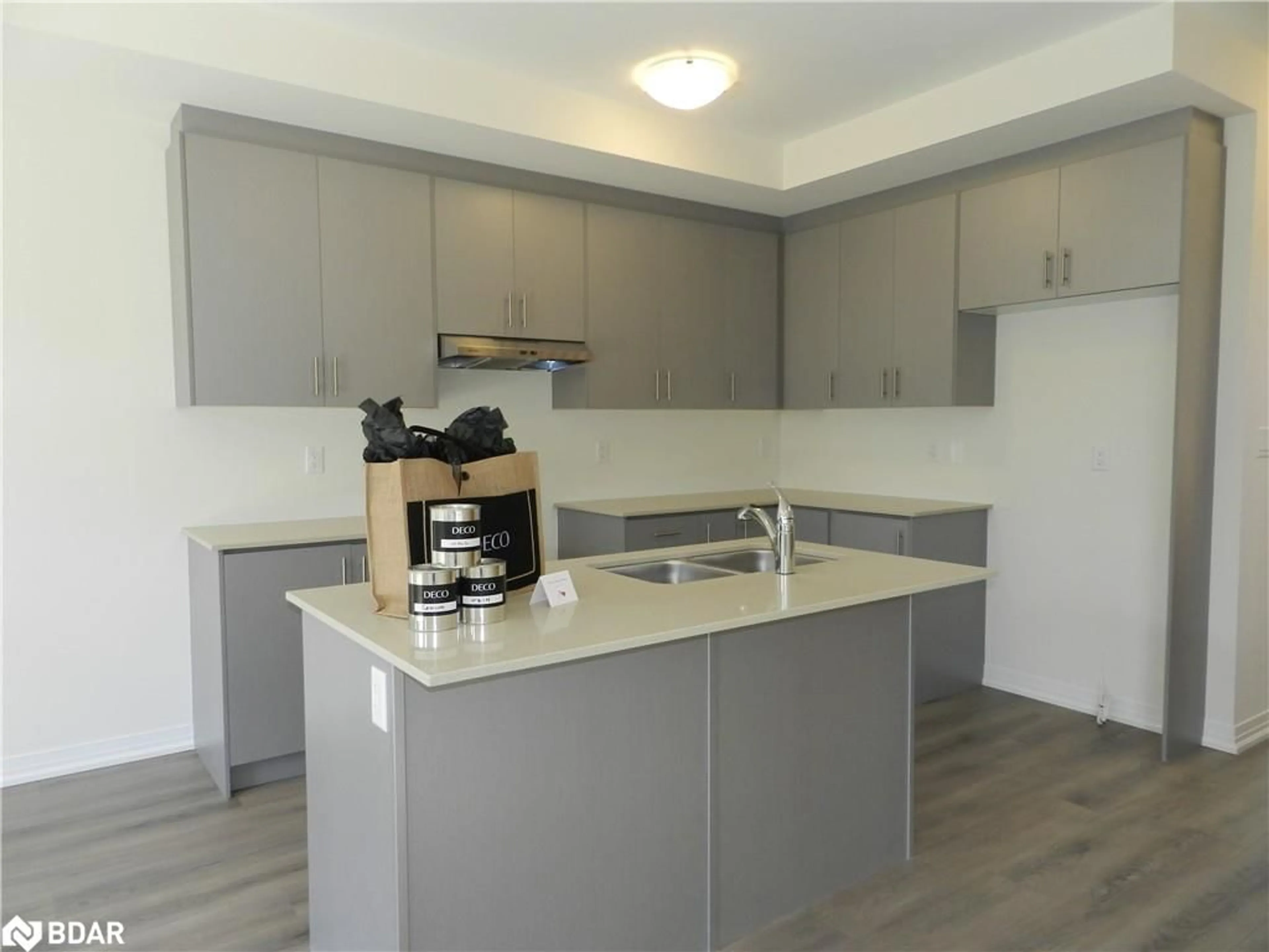 Open concept kitchen, wood/laminate floor for 38 Cherry Hill Lane, Barrie Ontario L9J 0M7