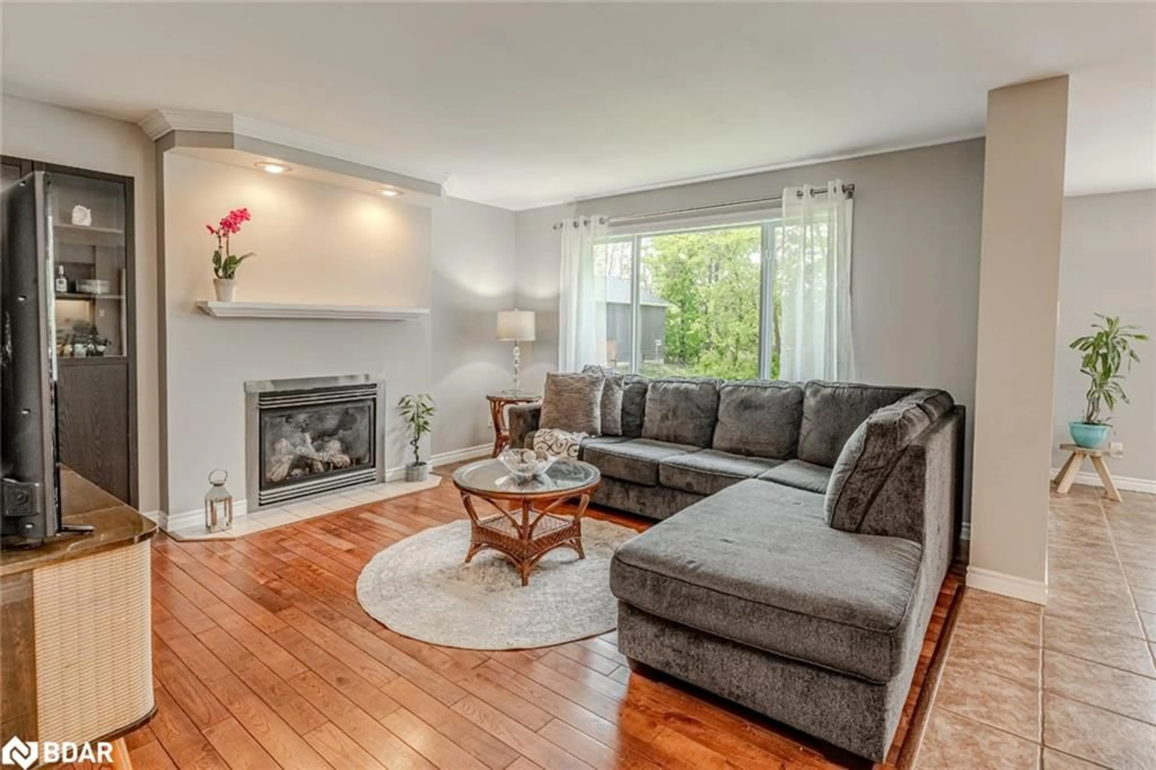 Living room with furniture, wood/laminate floor for 4653 Kurtis Dr, Ramara Ontario L3V 0K8
