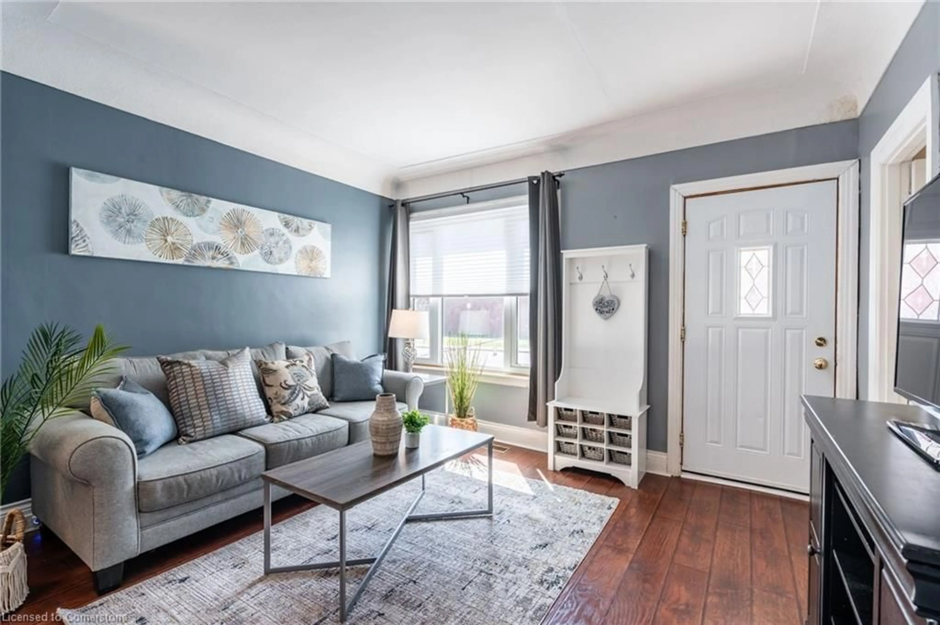 Living room with furniture, wood/laminate floor for 153 East 5th St, Hamilton Ontario L9A 2Z7