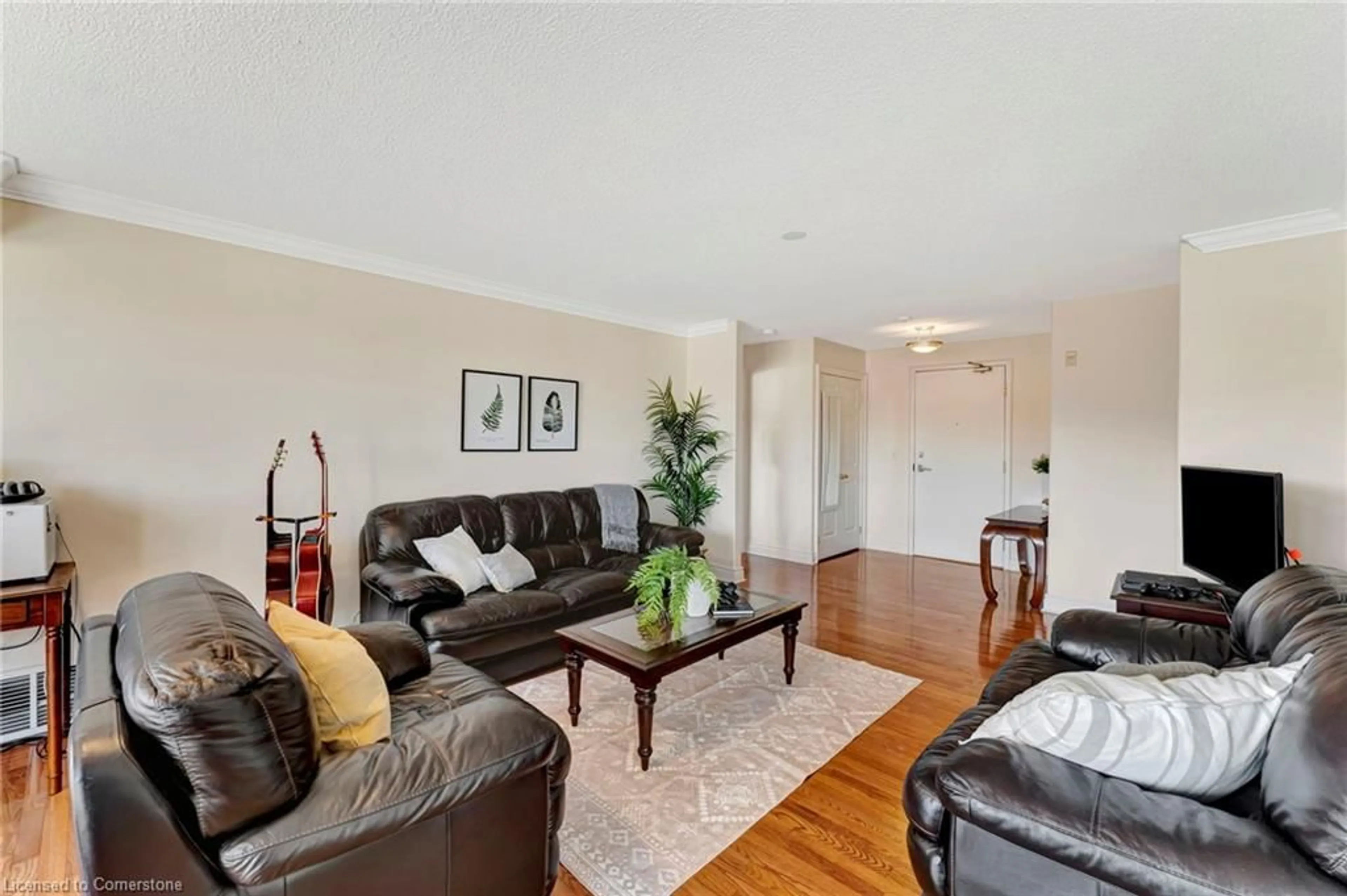 Living room with furniture, wood/laminate floor for 1770 Main St #506, Hamilton Ontario L8S 1H1