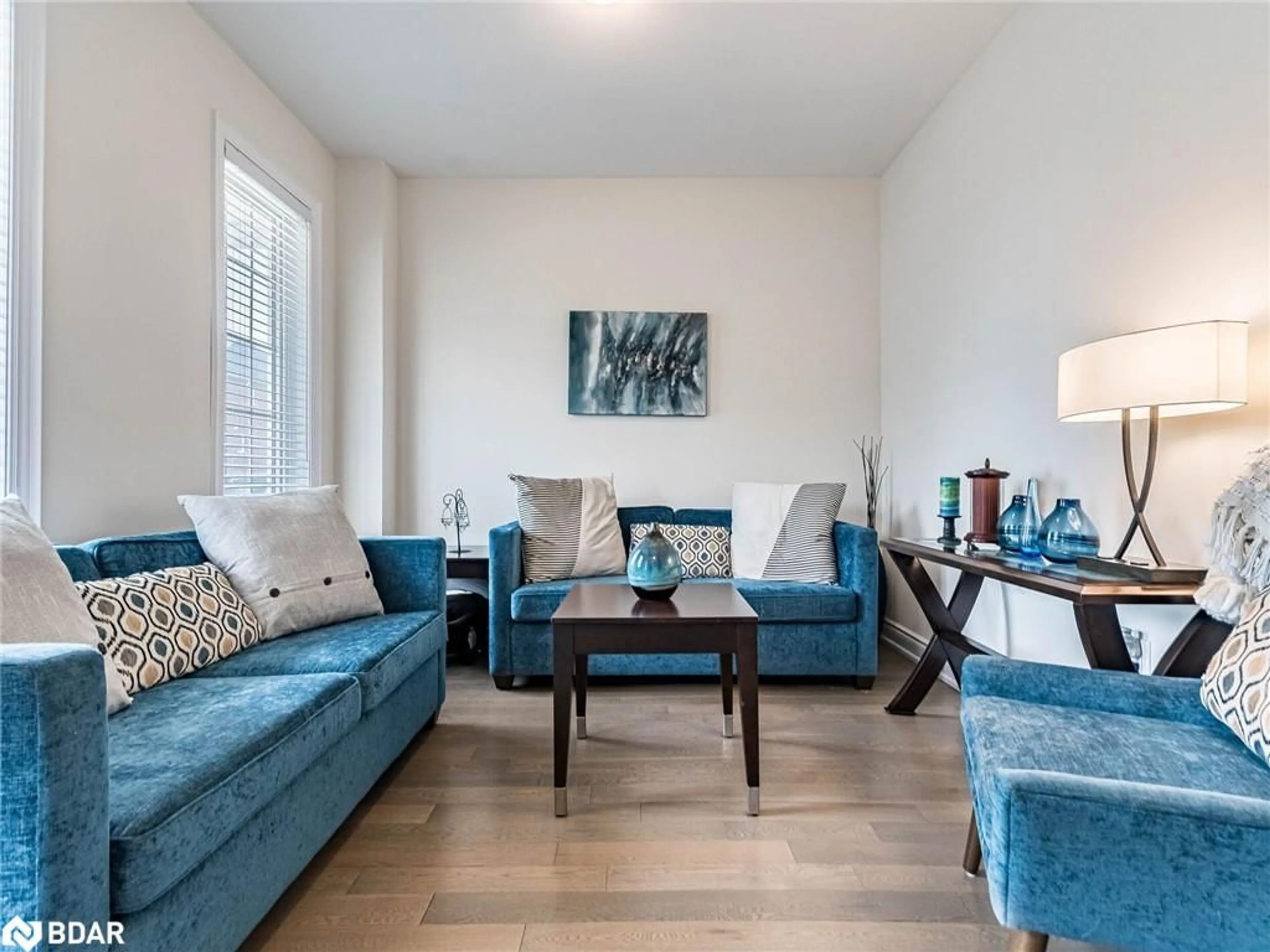 Living room with furniture, wood/laminate floor for 8779 Chickory Trail, Niagara Falls Ontario L2H 3S4
