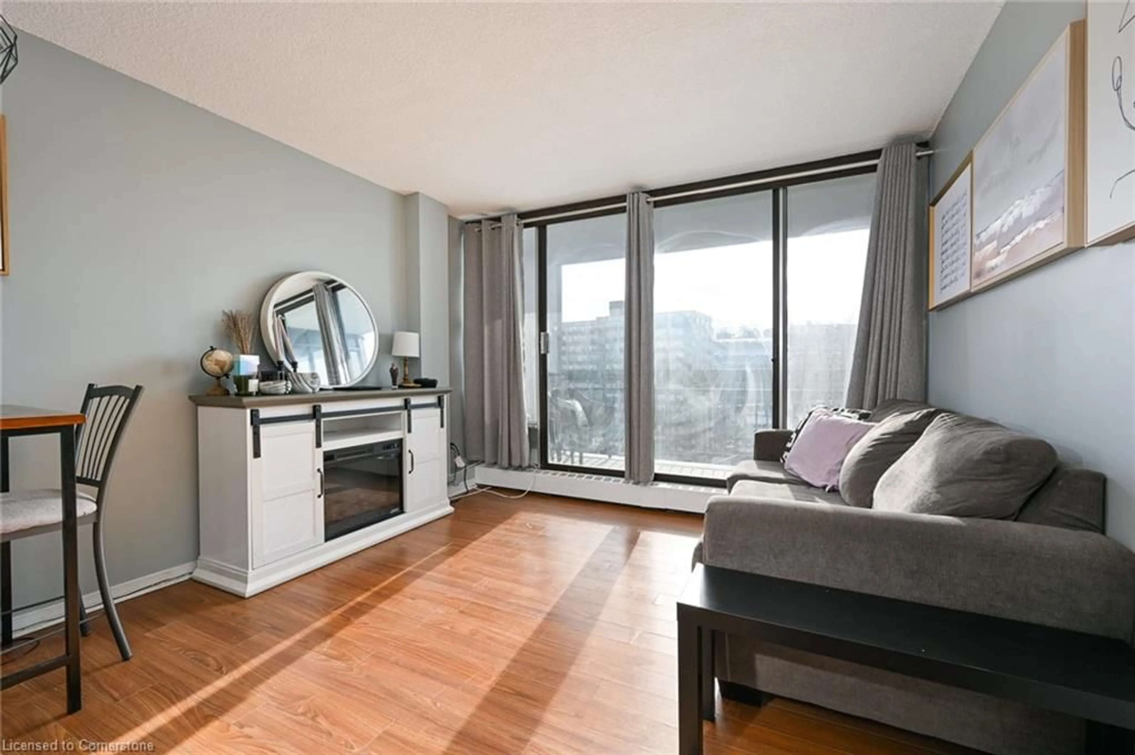 Living room with furniture, wood/laminate floor for 150 Charlton Ave #2605, Hamilton Ontario L8N 3X3
