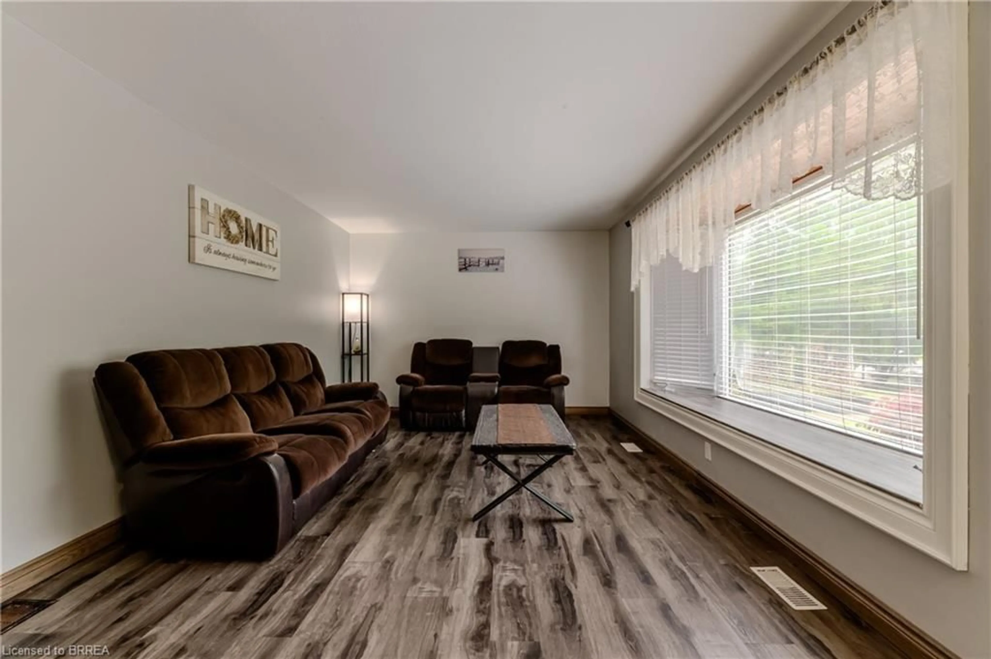 Living room with furniture, wood/laminate floor for 936 Windham 11 Rd, Delhi Ontario N0E 2A0