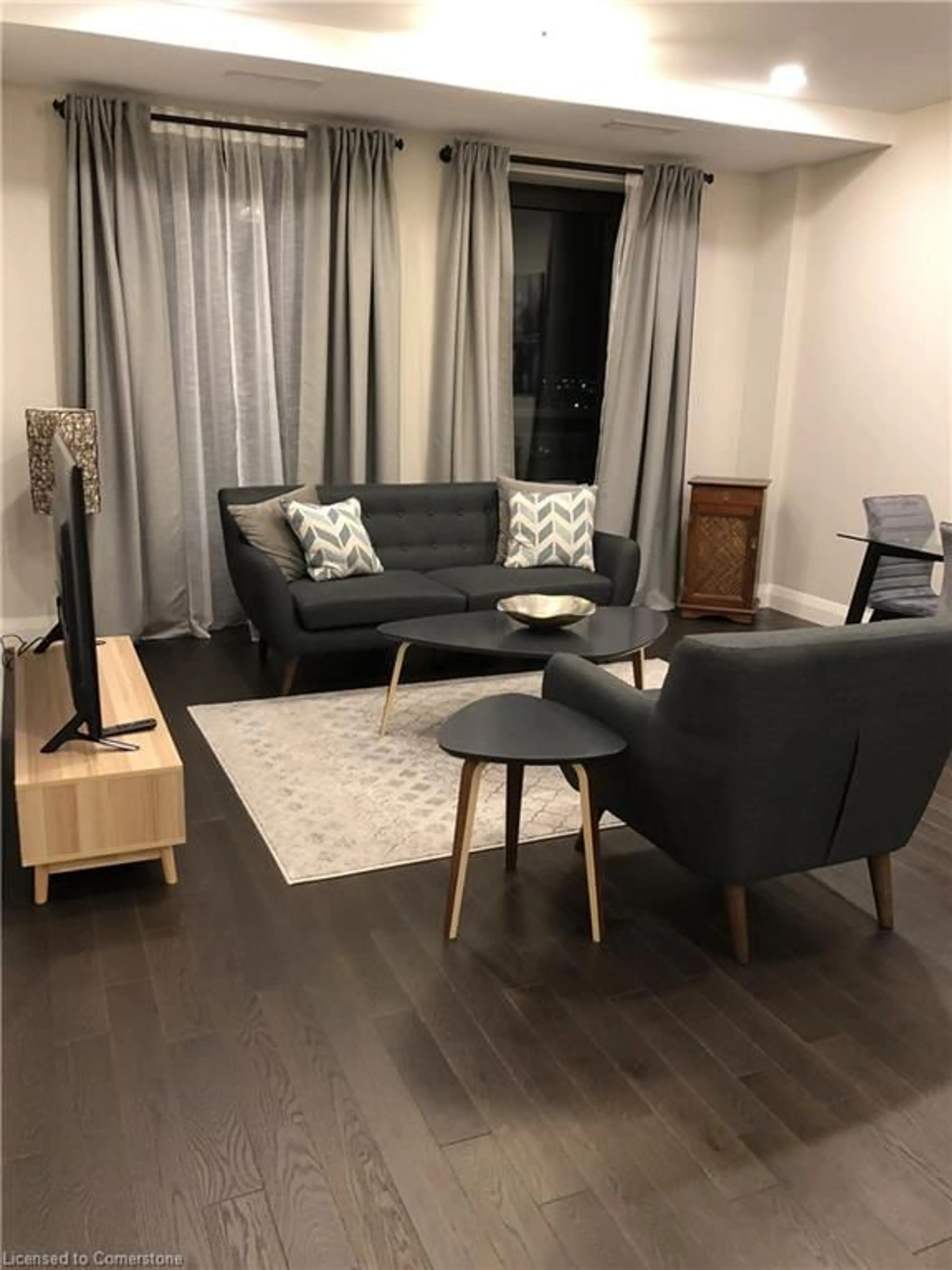 Living room with furniture, wood/laminate floor for 118 King Street East St #723, Hamilton Ontario L8N 1A8