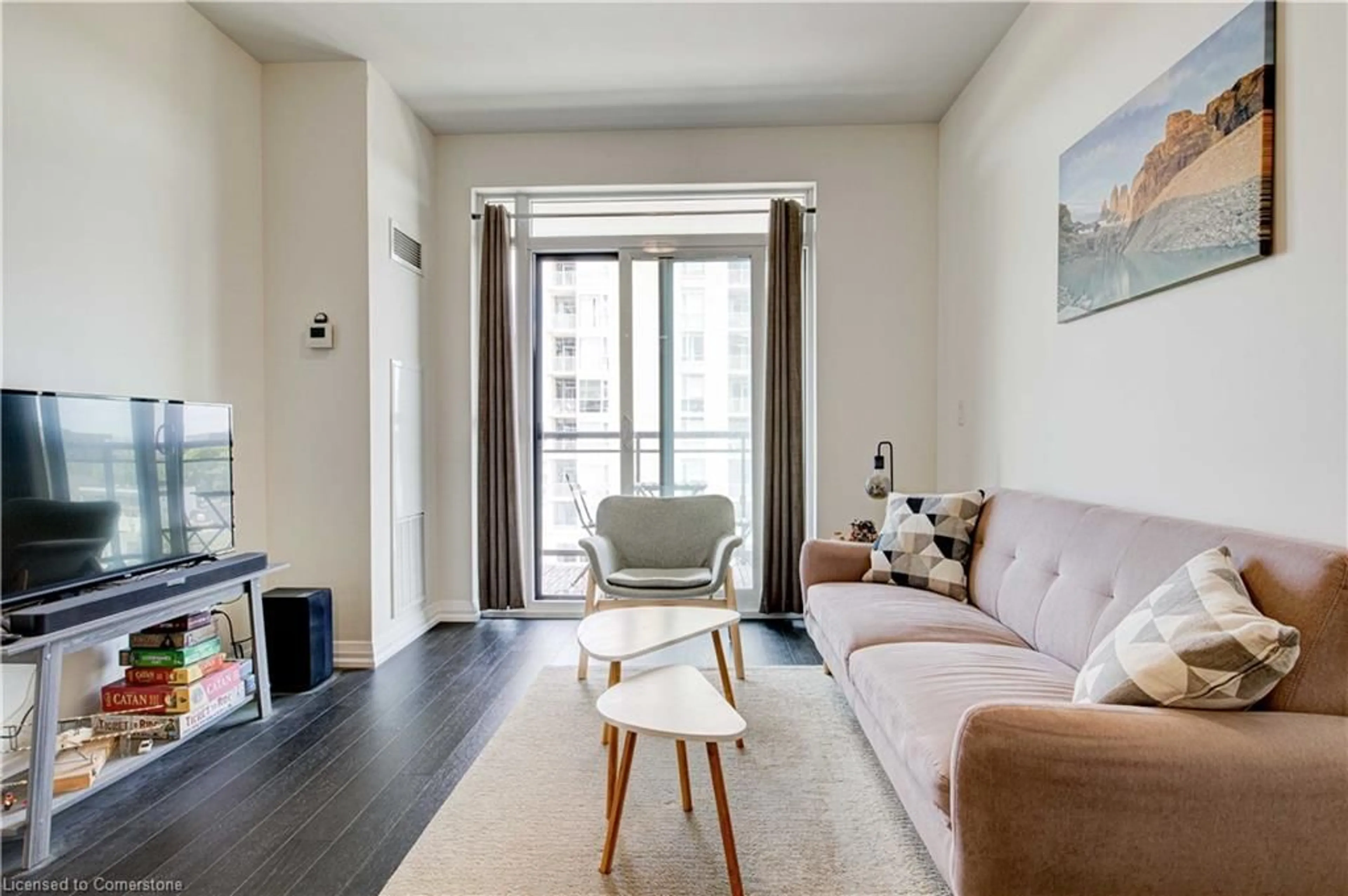 Living room with furniture, wood/laminate floor for 155 Caroline St #603, Waterloo Ontario N2L 0J8