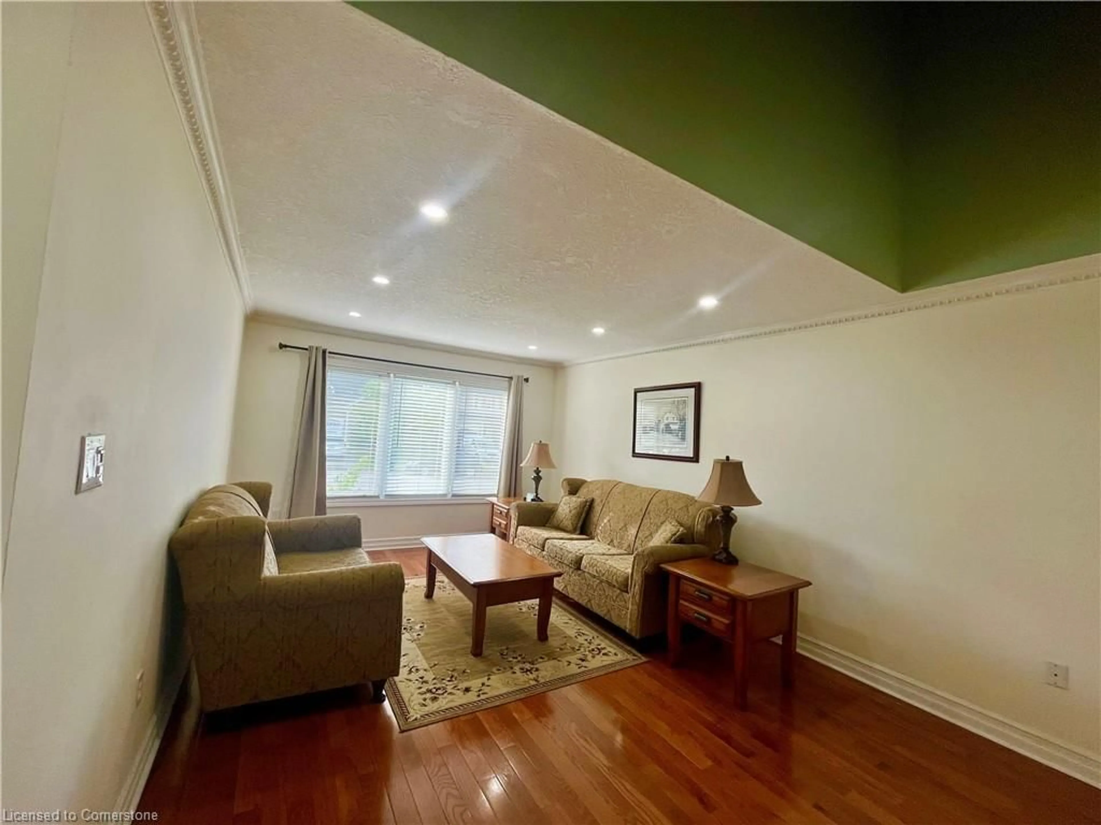 Living room with furniture, wood/laminate floor for 47 Gaydon Way, Brantford Ontario N3T 6P7