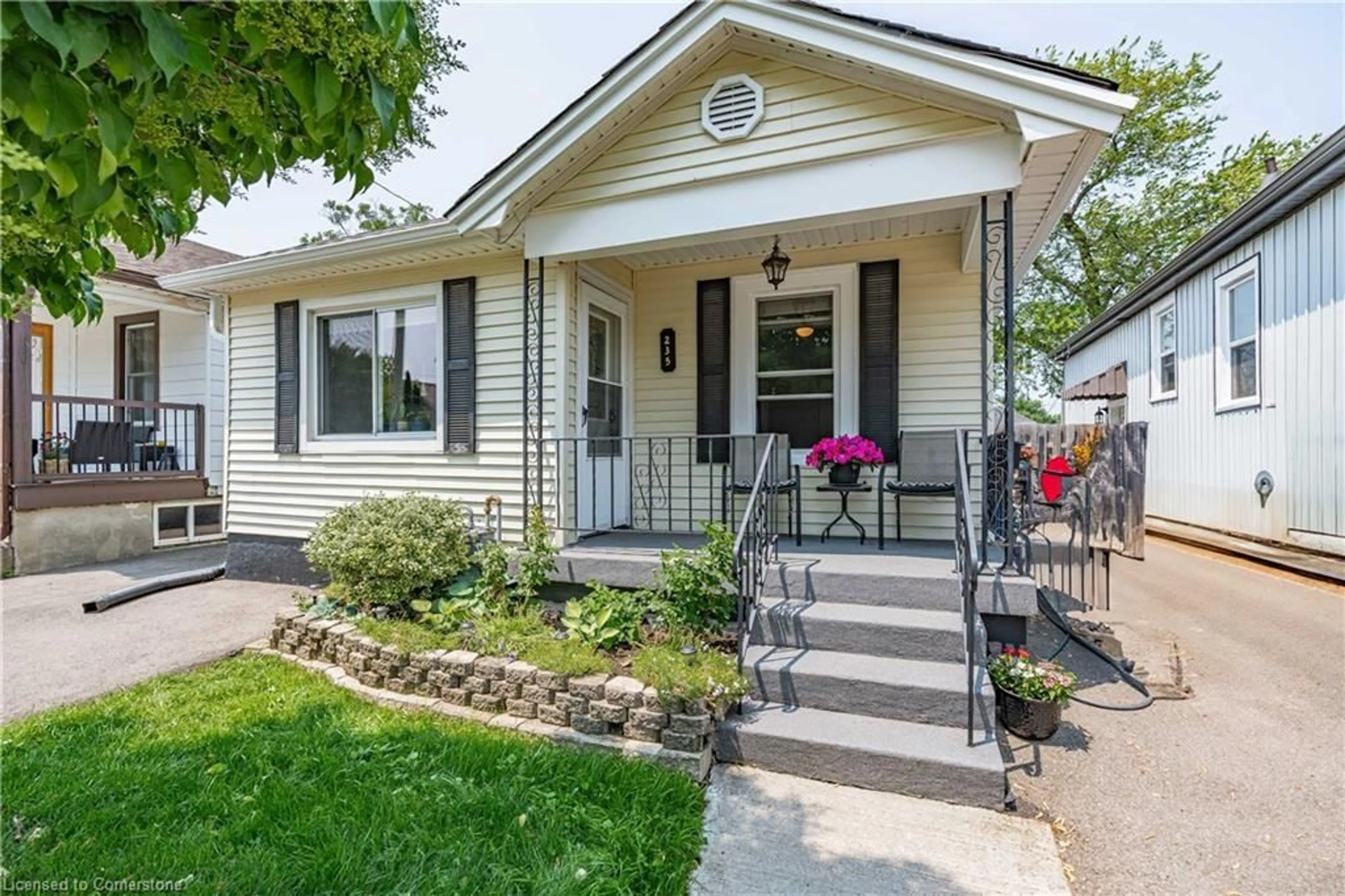 Home with vinyl exterior material, street for 235 Tolton Ave, Hamilton Ontario L8H 5P2