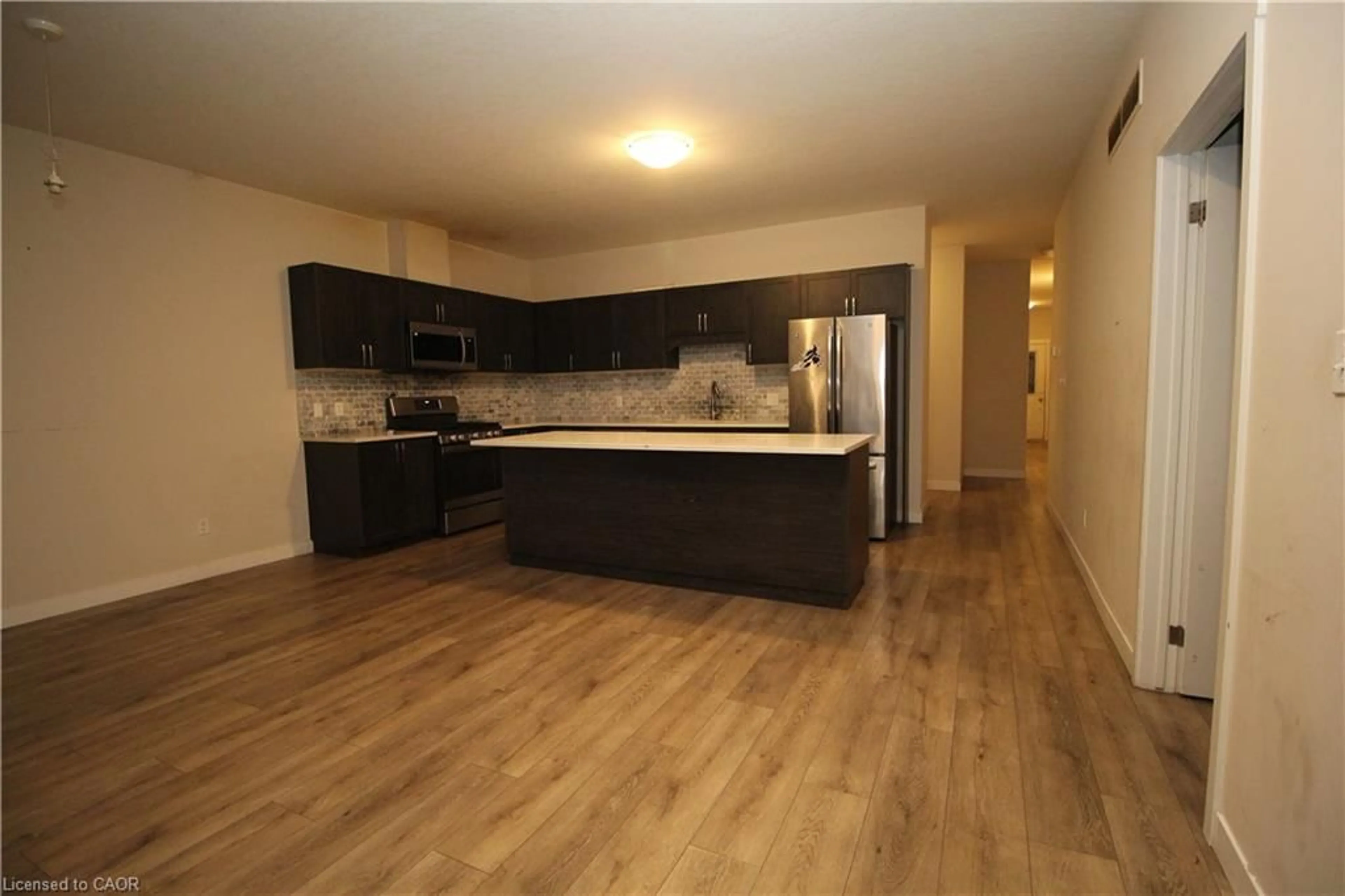 Open concept kitchen, wood/laminate floor for 15 Meadowhawk Lane, Simcoe Ontario N3W 0E8
