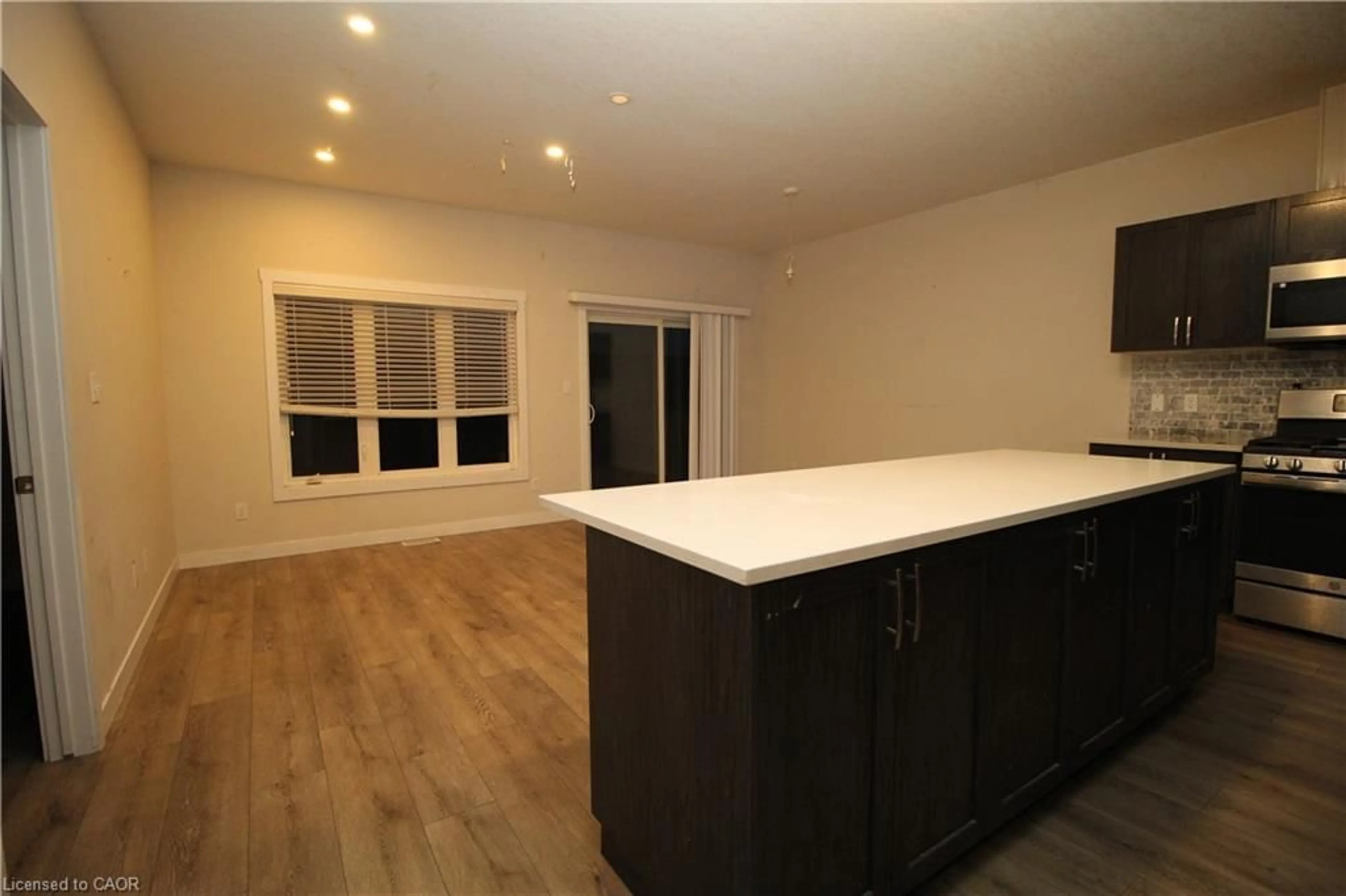 Open concept kitchen, wood/laminate floor for 15 Meadowhawk Lane, Simcoe Ontario N3W 0E8