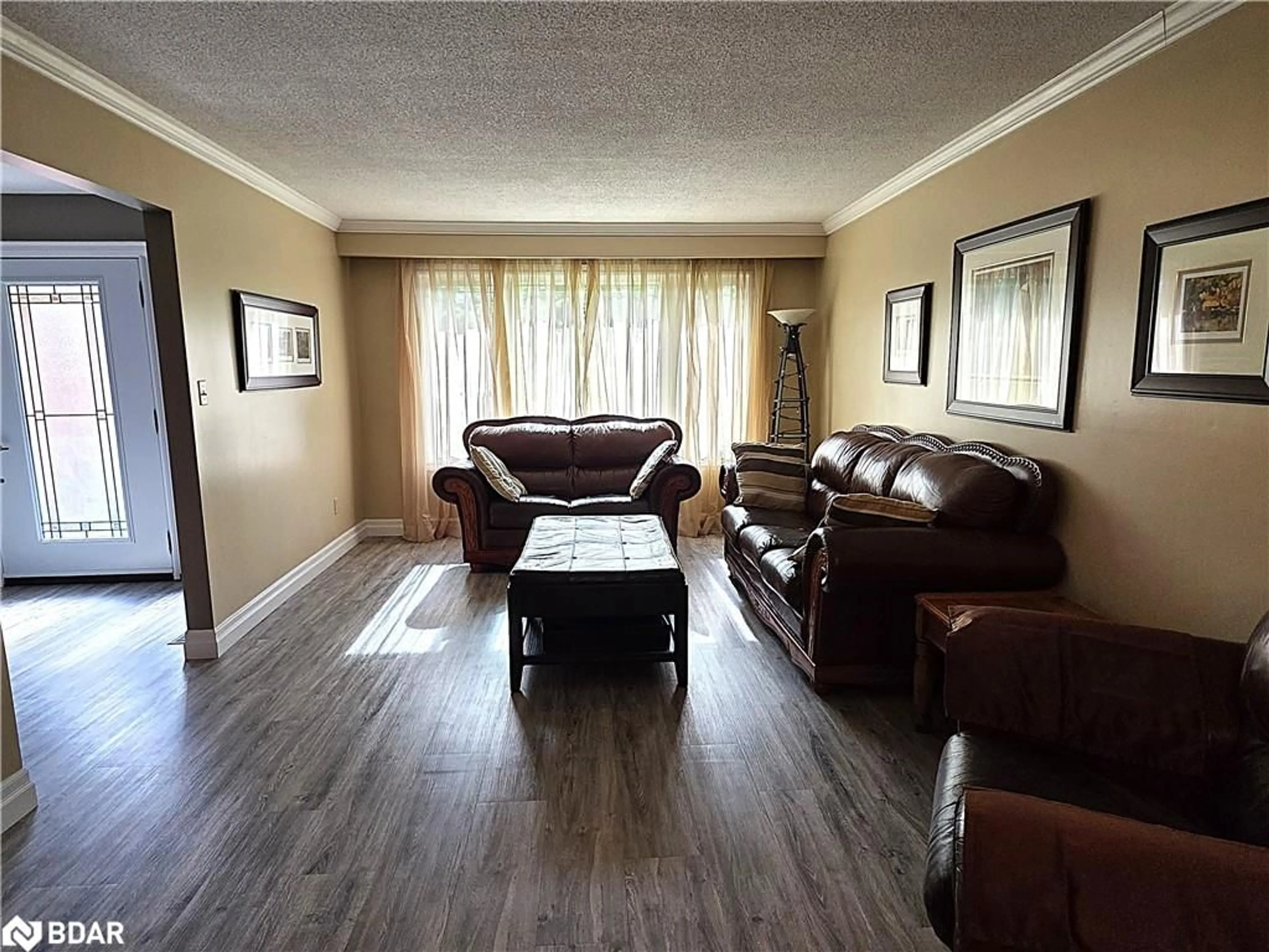 Living room with furniture, wood/laminate floor for 188 Browning Trail, Barrie Ontario L4N 5H2