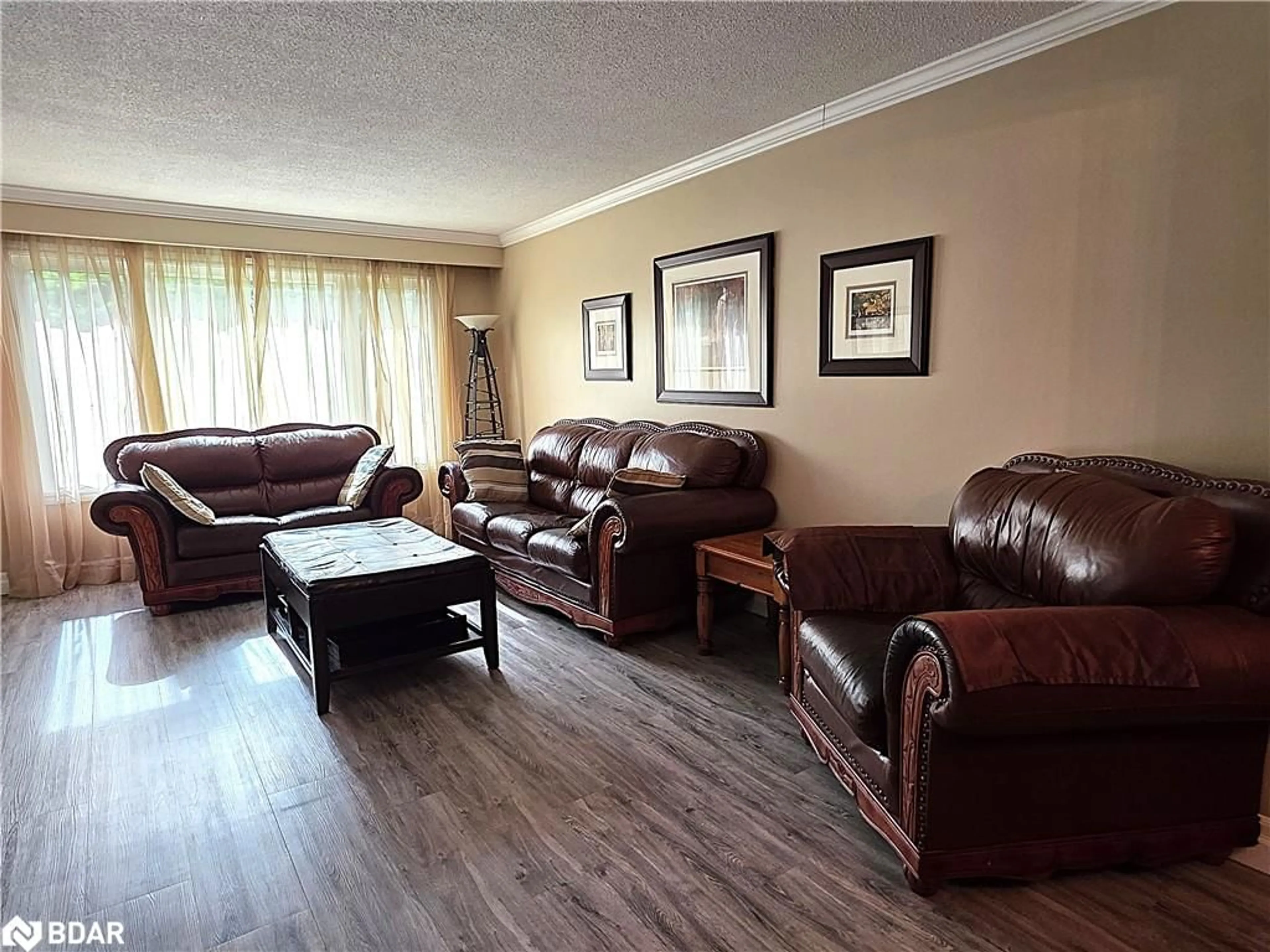 Living room with furniture, wood/laminate floor for 188 Browning Trail, Barrie Ontario L4N 5H2