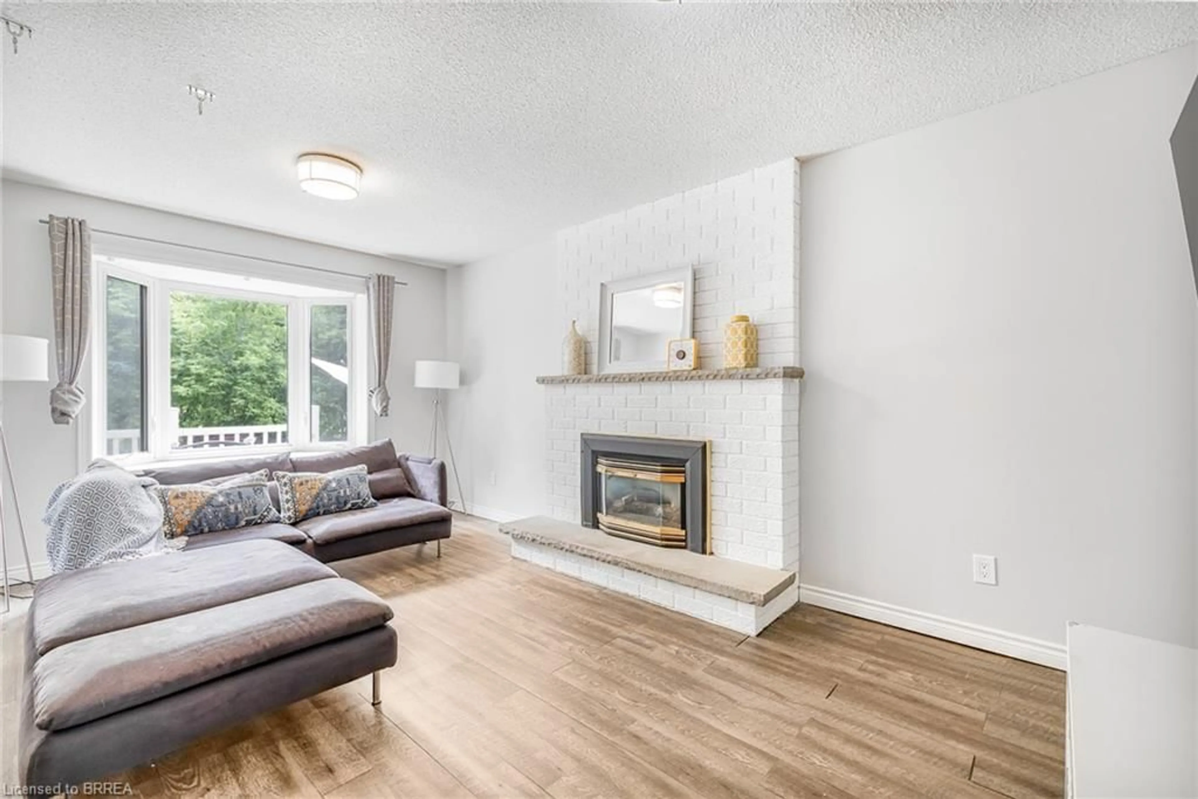 Living room with furniture, wood/laminate floor for 26 Dundalk Cres, Brampton Ontario L6Z 2V2