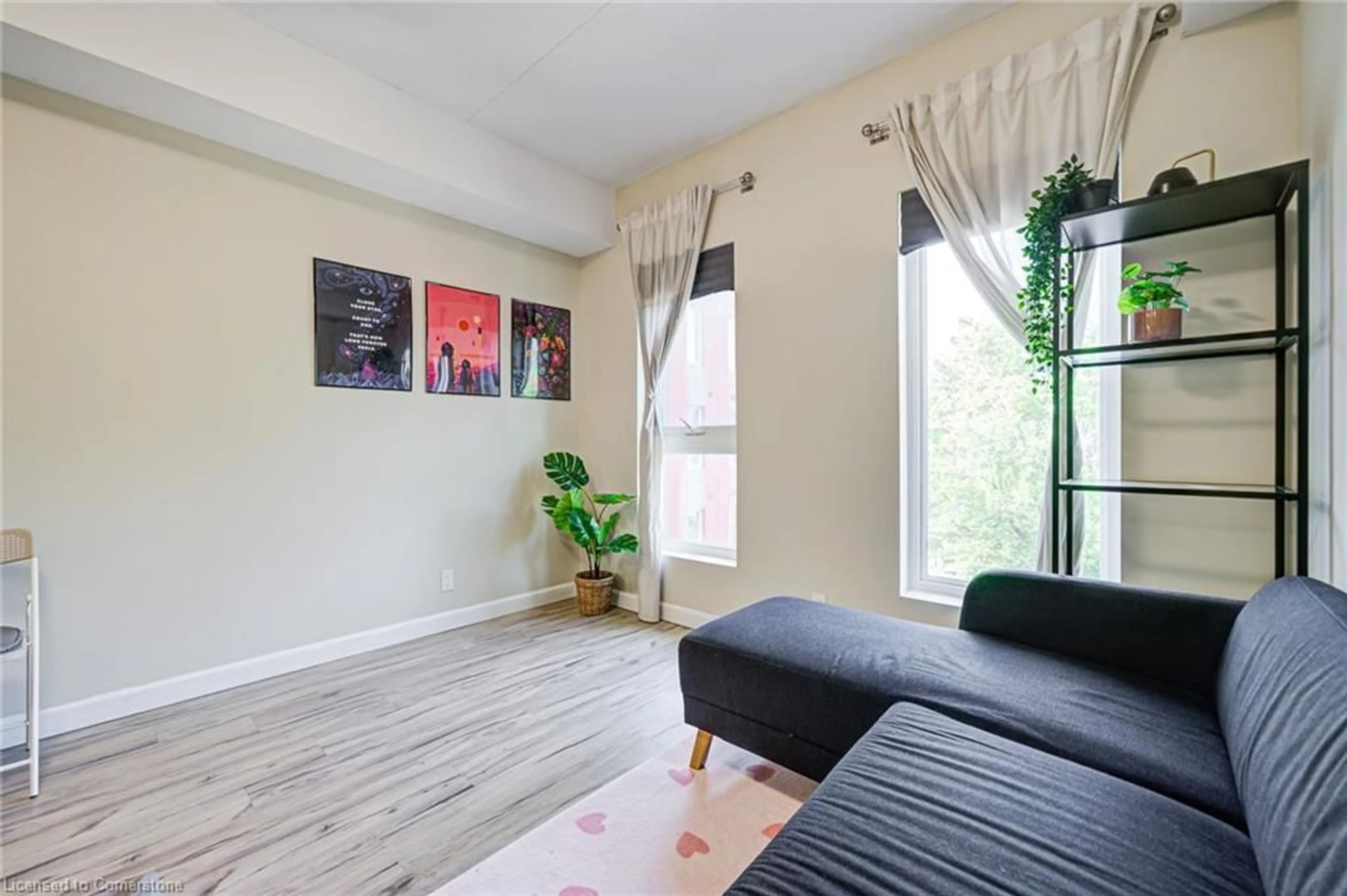 Living room with furniture, wood/laminate floor for 77 Leland St #423, Hamilton Ontario L8S 3A1