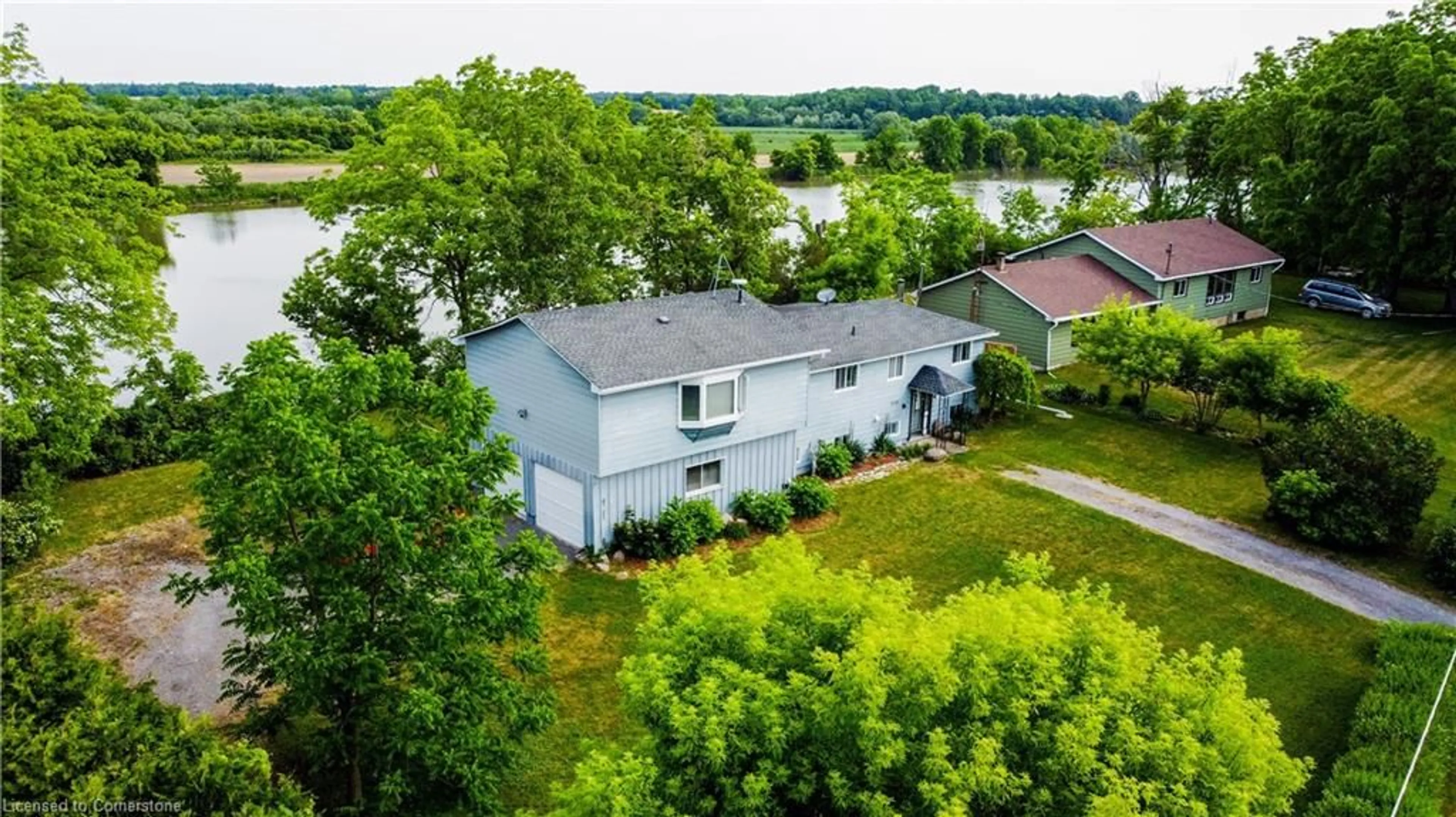 A pic from outside/outdoor area/front of a property/back of a property/a pic from drone, water/lake/river/ocean view for 1028 River Rd, Cayuga Ontario N0A 1E0