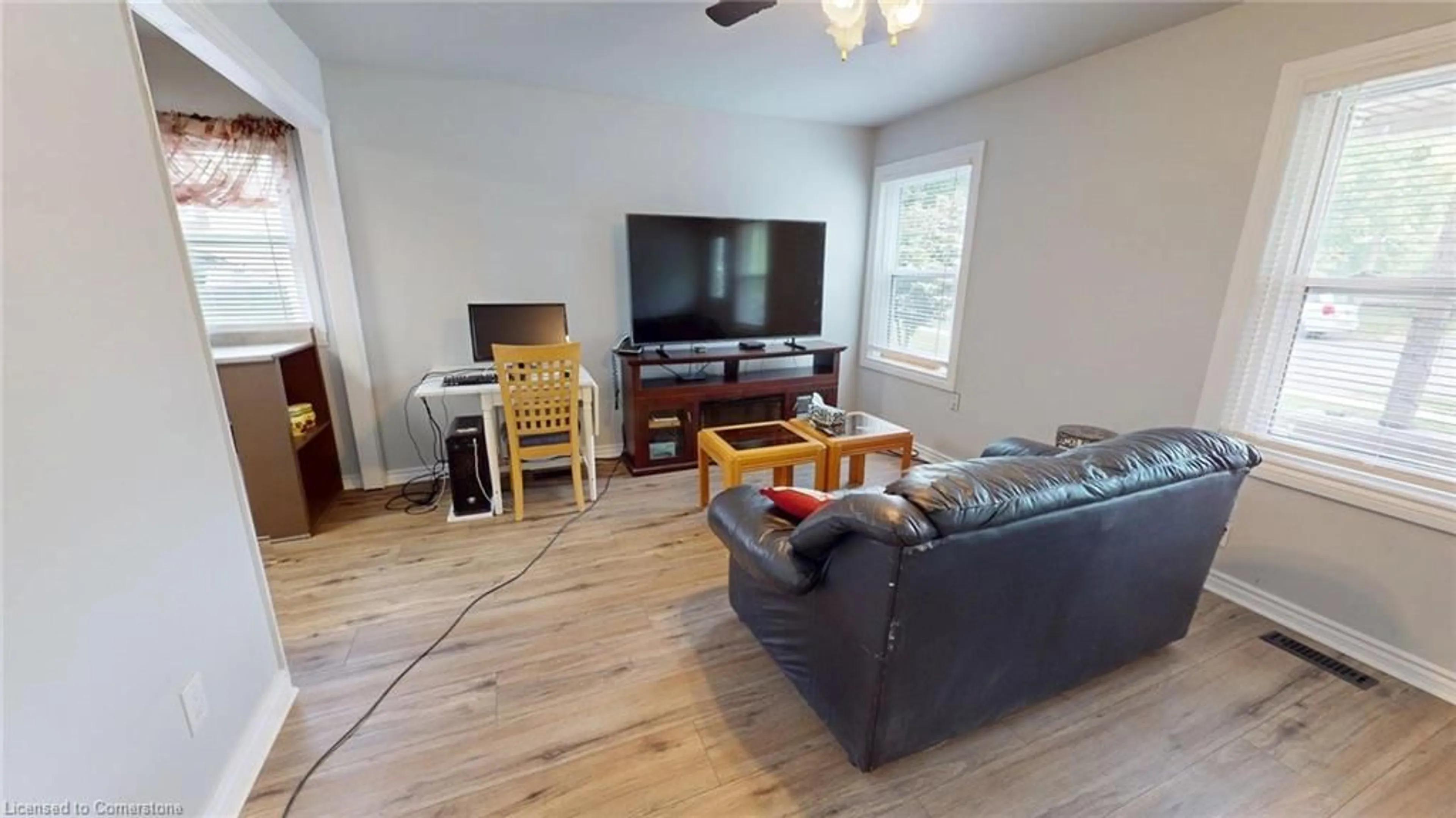 Living room with furniture, wood/laminate floor for 12 Hayes St, St. Catharines Ontario L2T 1N6