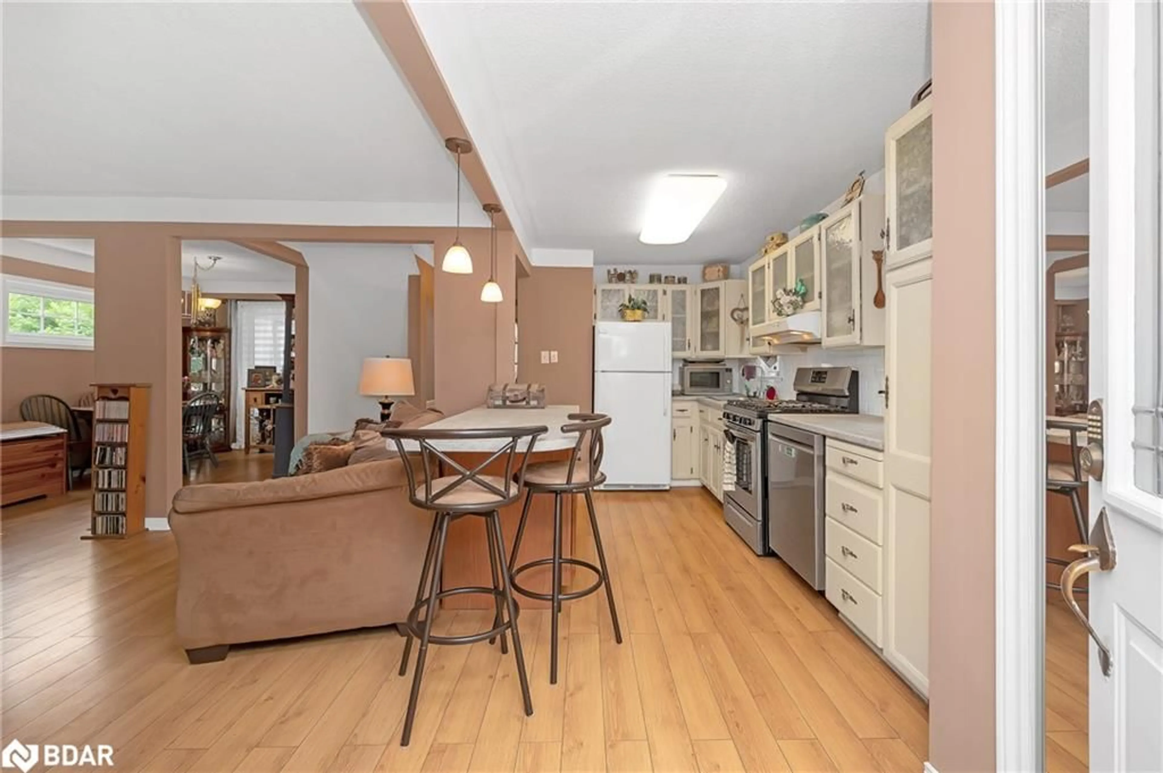 Open concept kitchen, wood/laminate floor for 164 Adair Ave, Hamilton Ontario L8H 6A9