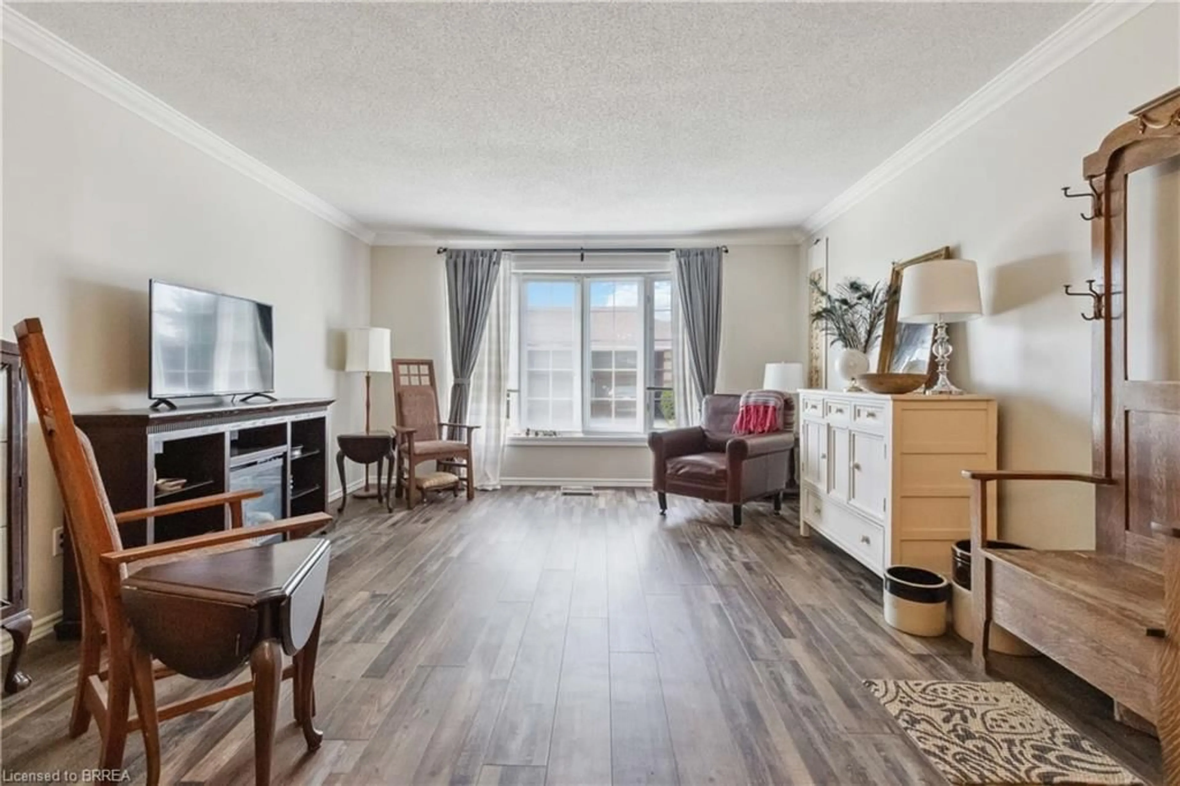 Living room with furniture, wood/laminate floor for 20 Courtland Dr #8, Brantford Ontario N3R 7Y2