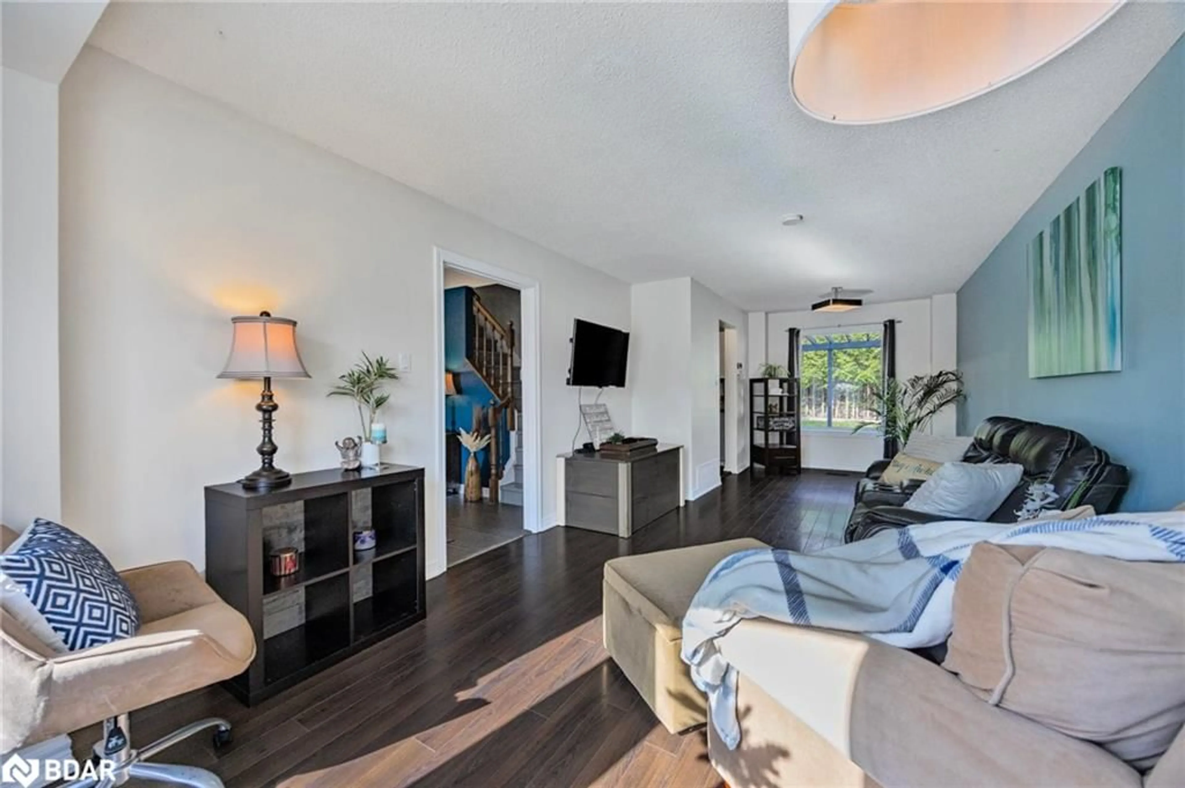 Living room with furniture, wood/laminate floor for 1057 Vance Cres, Innisfil Ontario L9S 1V6