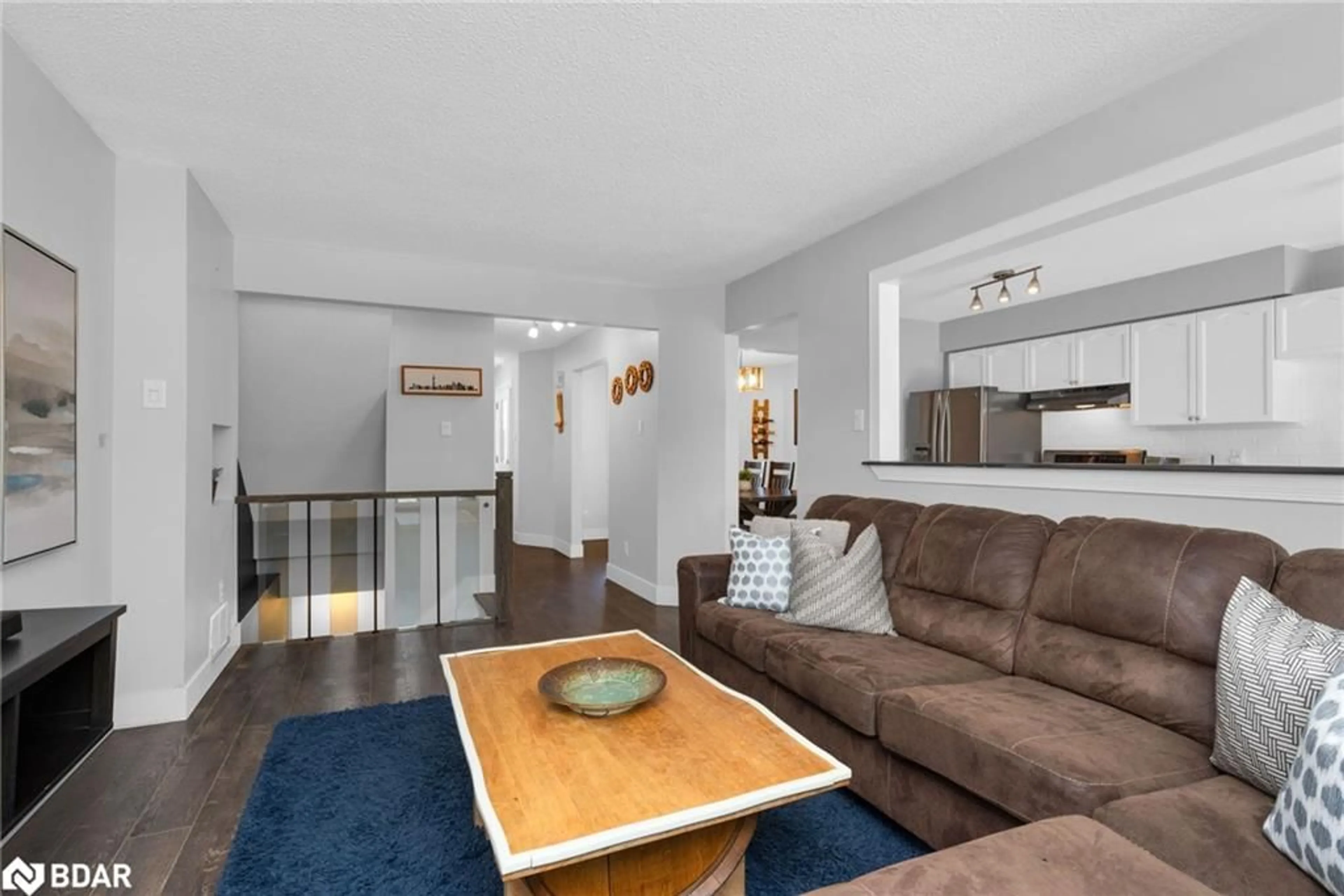 Living room with furniture, wood/laminate floor for 50 Rosenfeld Dr, Barrie Ontario L4M 5X4
